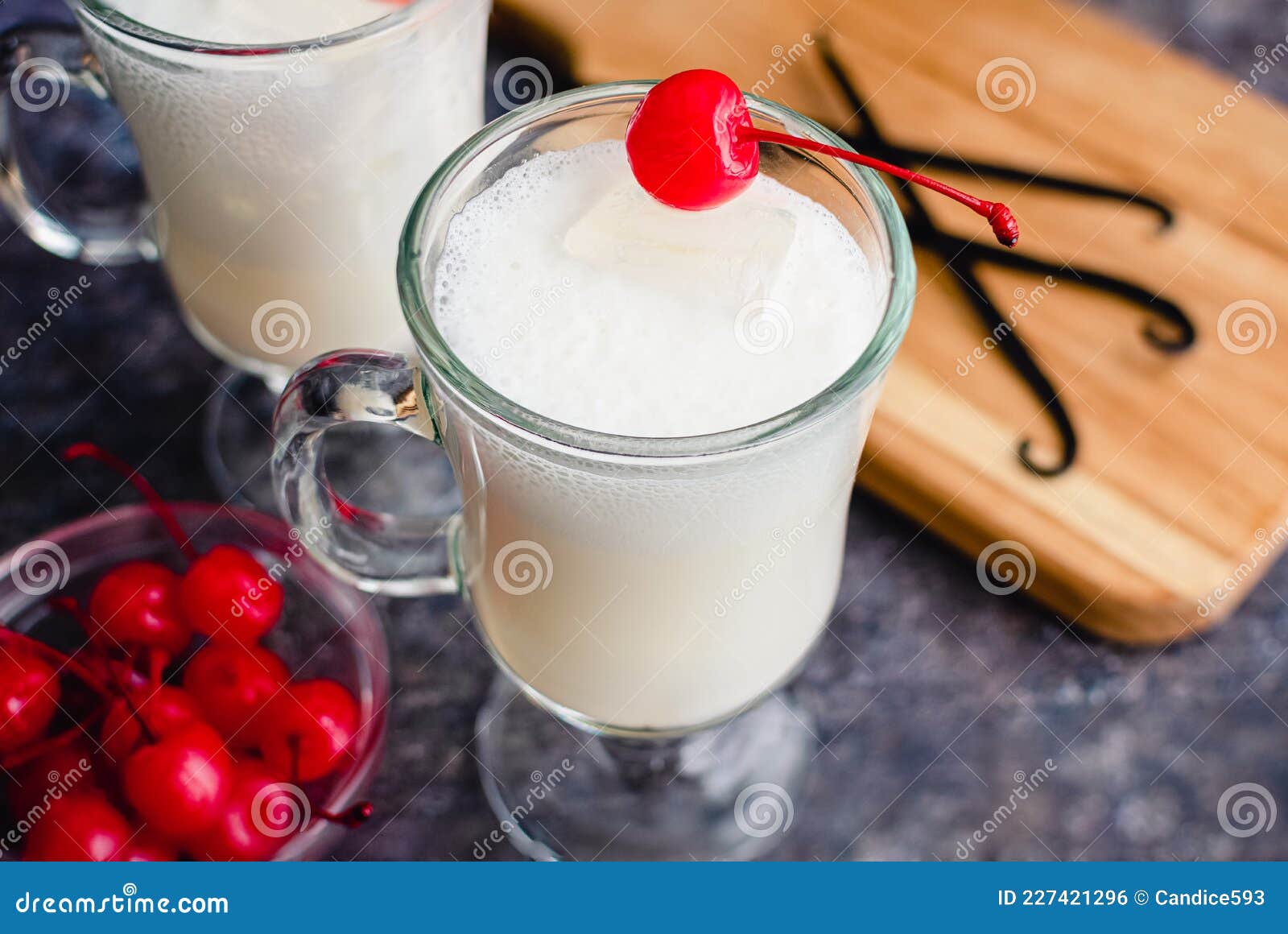 Vanilla Italian Sodas Garnished with Maraschino Cherries in Glass Mugs