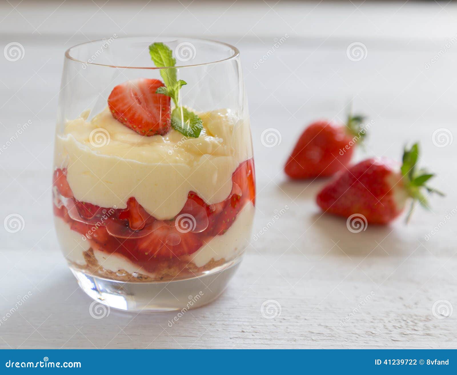 vanilla pudding with tipsy strawberries on wood