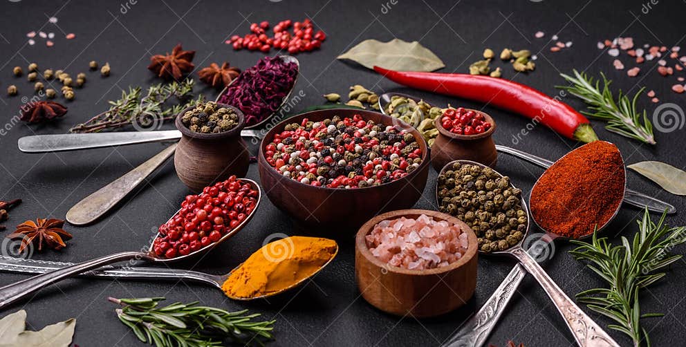 Variation of Spices in Metal Spoons Paprika, Turmeric, Cardamom, a ...