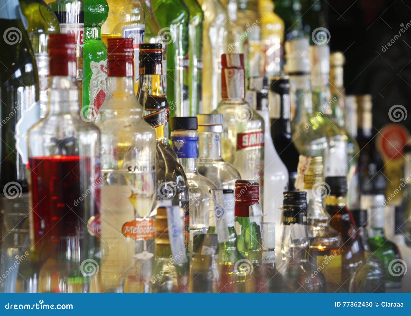 Variety of alcohol bottles editorial image. Image of night 77362430