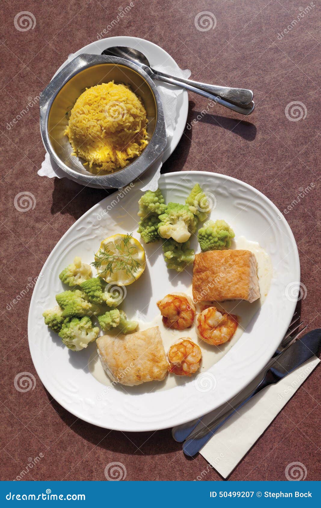 Variety of Fish and Fillet is Served with Saffron Rice in Plate Stock