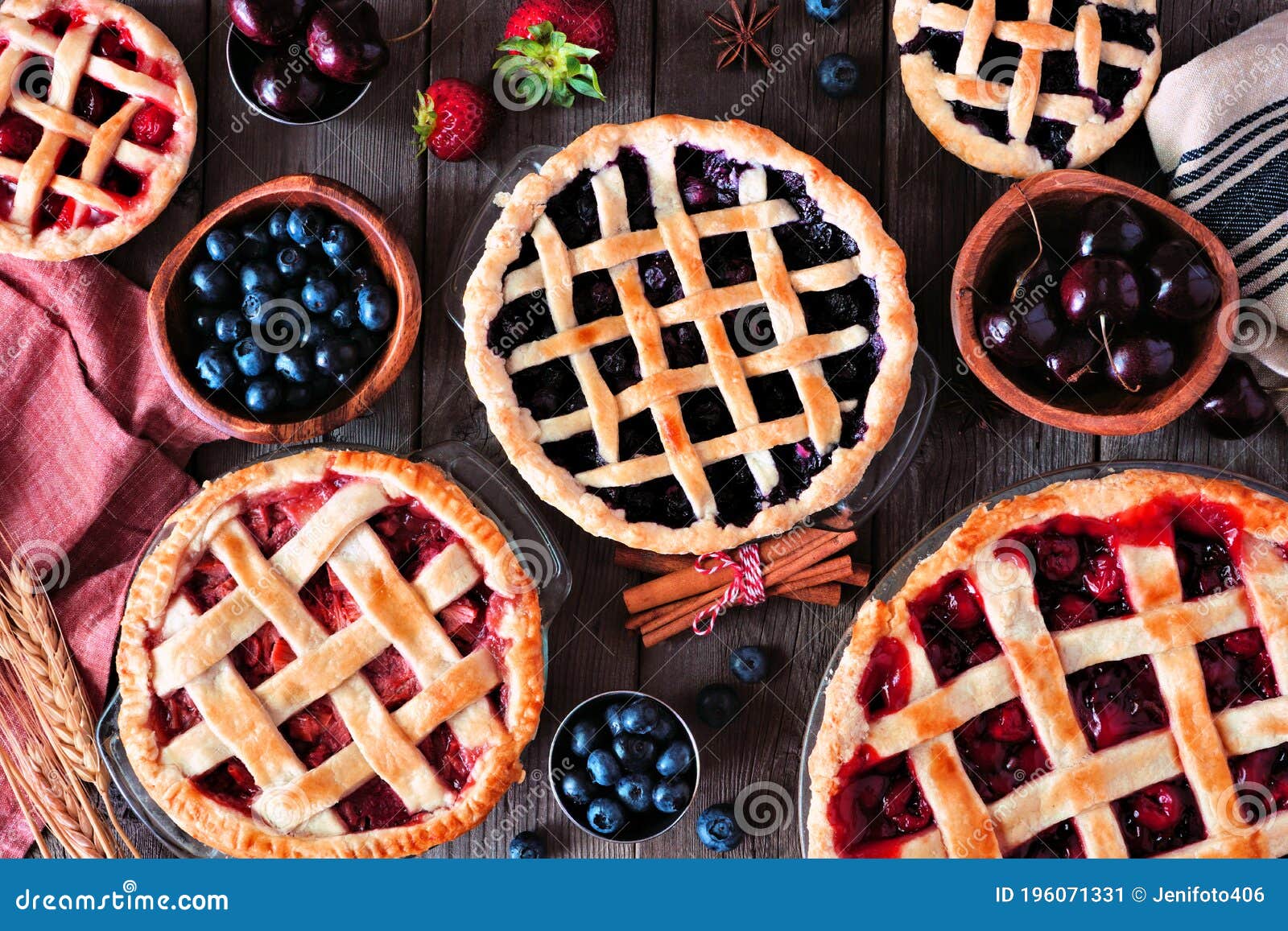 variety of homemade fruit pies. top view table scene over rustic wood.