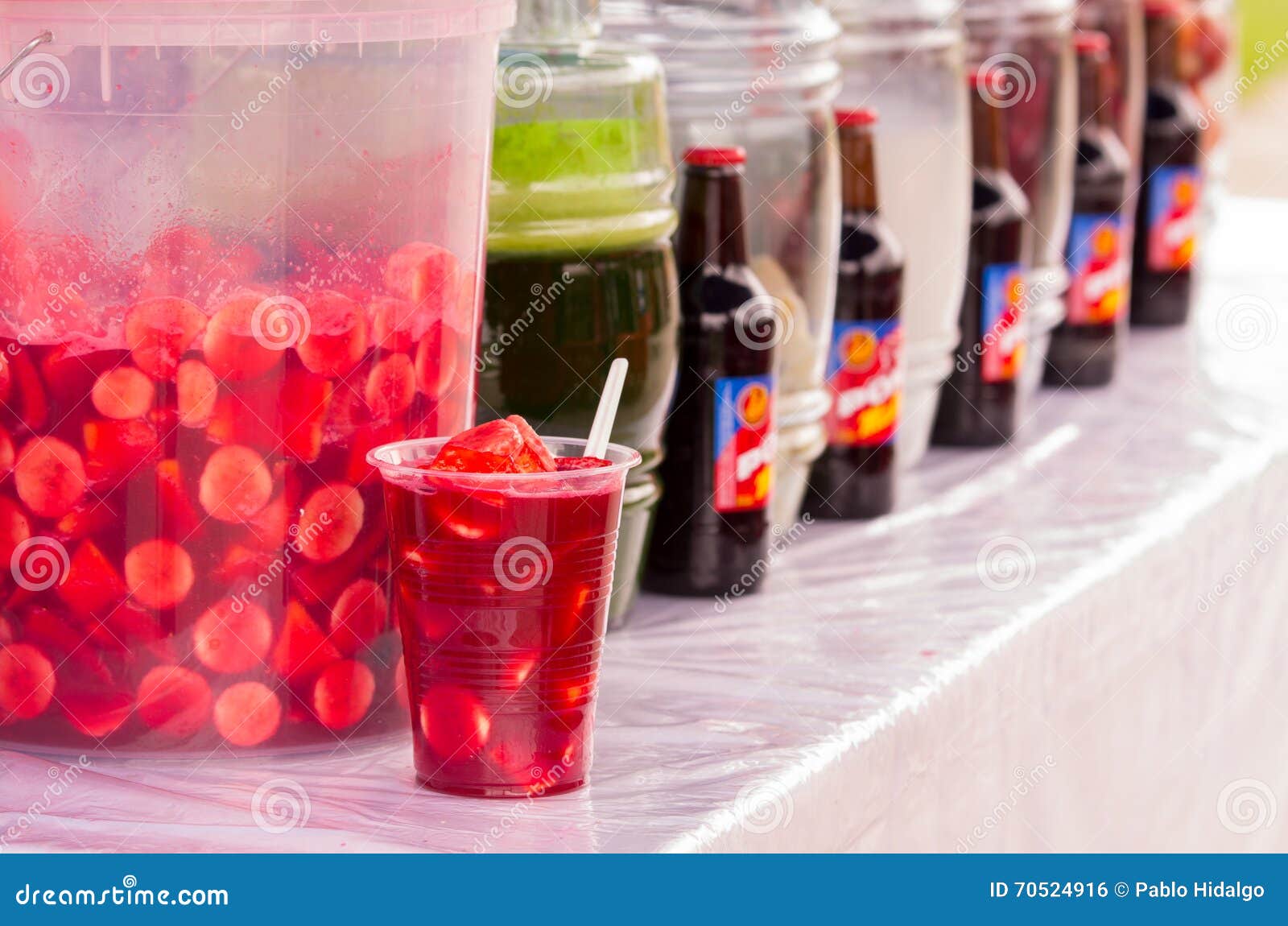 various beverages on market, traditional come y bebe on plastic glass