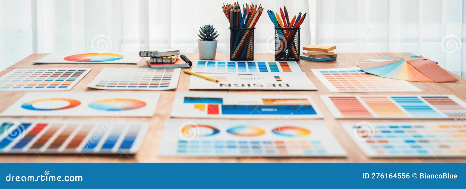 Various Color Palette Idea Papers Arranged on Workspace for Designer