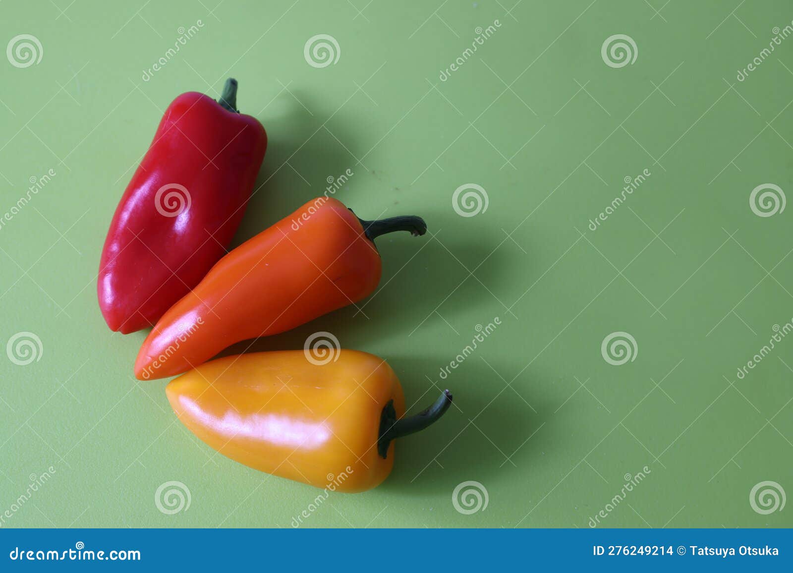 Various Color of Paprikas Isolated on a Green Background Stock Photo