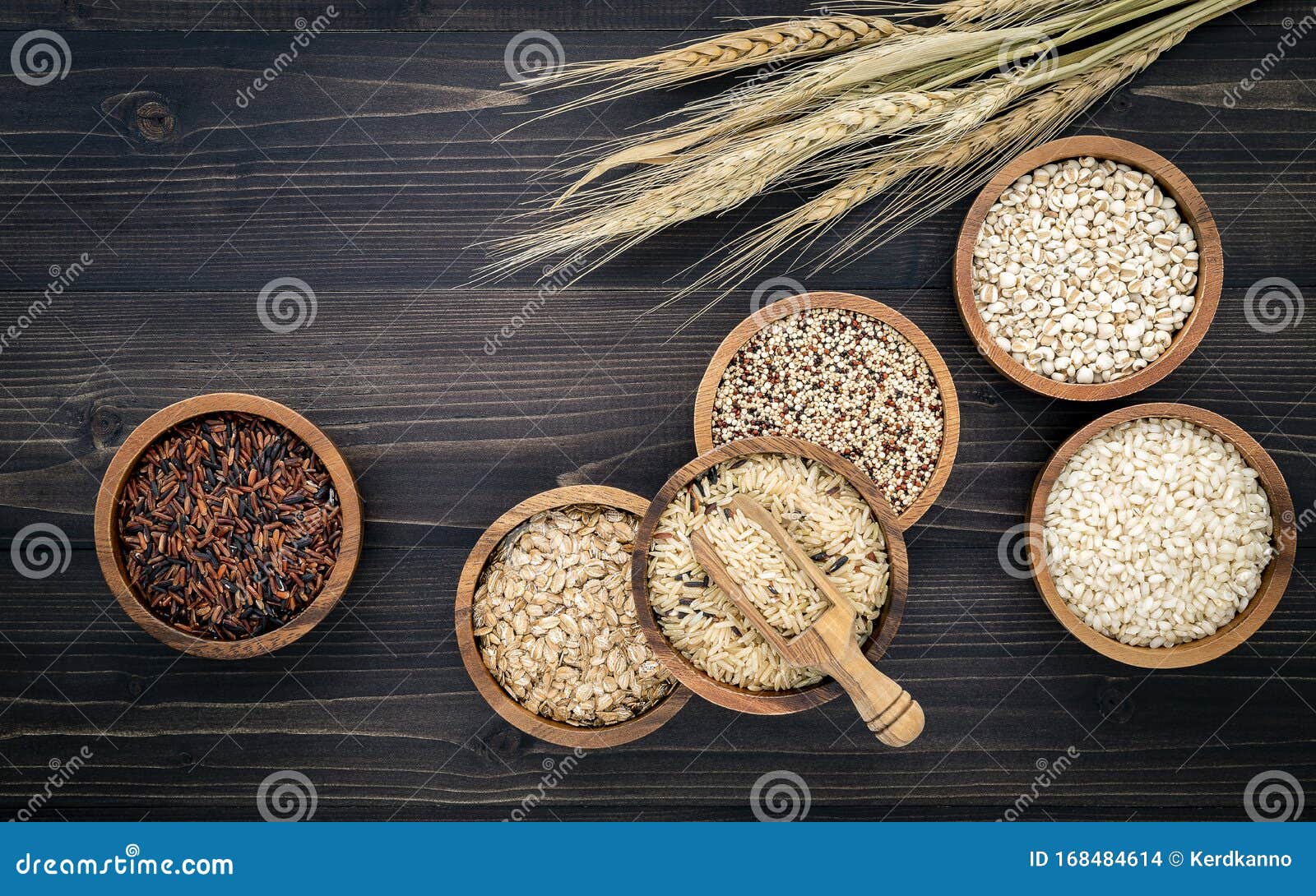 various natural organic cereal and whole grains seed in wooden bowl for healthy food ingredient product concept