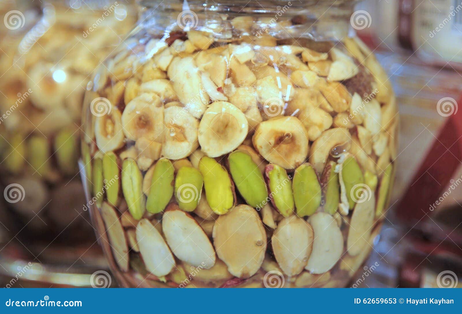 Healthy Mix Of Natural Honey With Different Nuts In A Jar On Blue Concrete  Background Stock Photo, Picture and Royalty Free Image. Image 109224603.