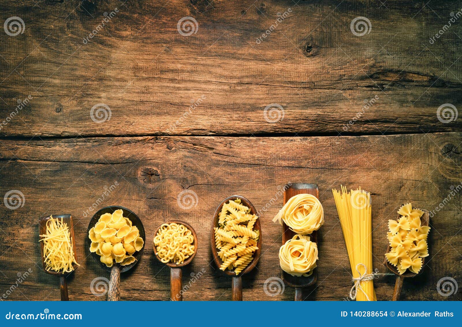 Various Pasta On Spoons Over Wooden Background Stock Photo Image of