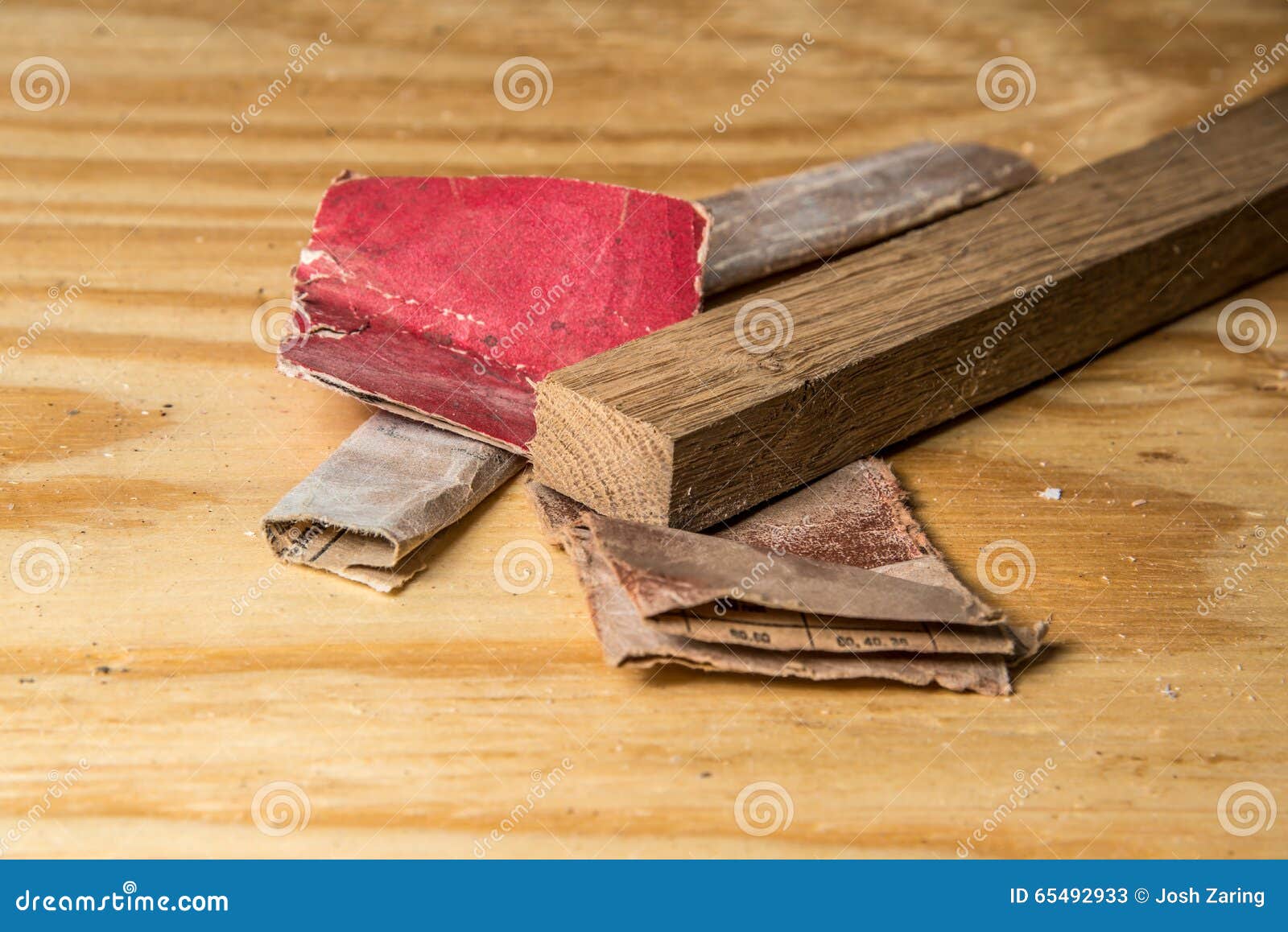 Various Sandpaper and Oak Wood on Pine Workbench Endgrain Stock Image