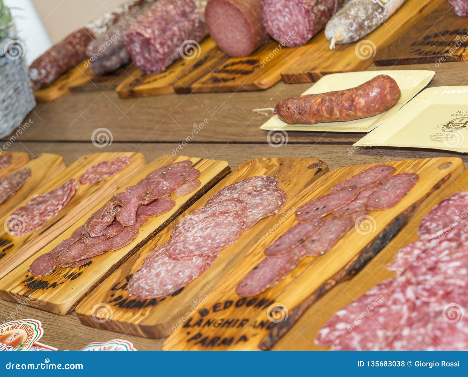 Various Types of Italian Sliced Salami on Wooden Chopping Boards Stock
