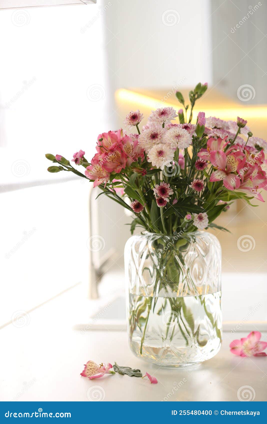 Vase with Beautiful Flowers on Kitchen Counter. Stylish Element of
