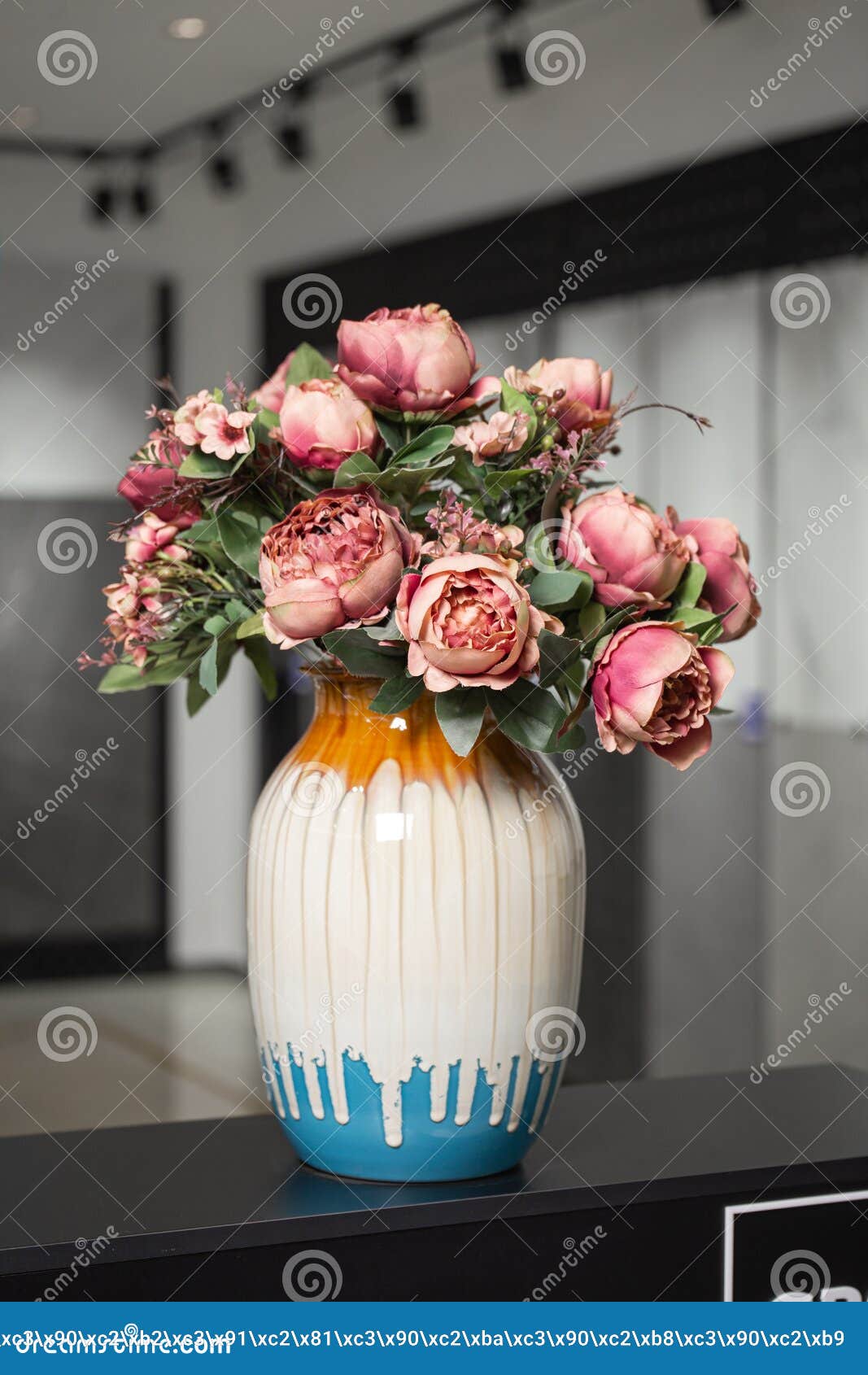 Vase with Pink Artificial Flowers in the Interior. Stock Photo Image