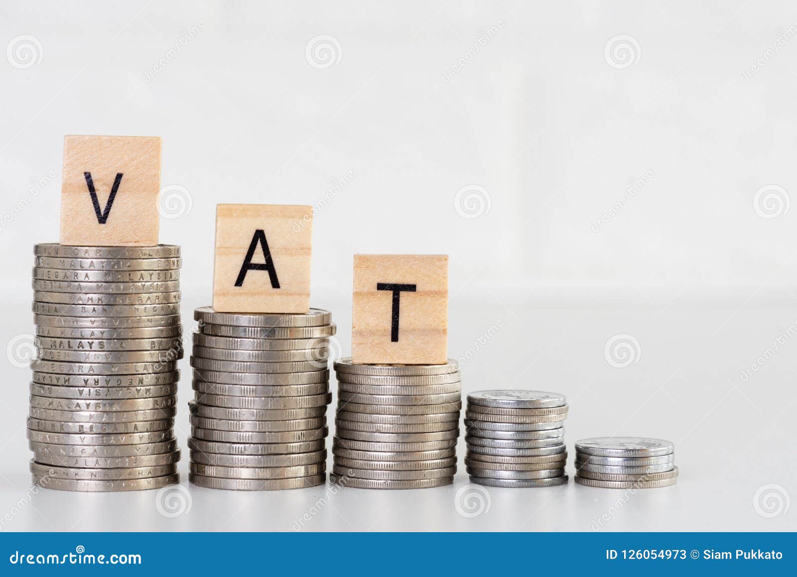 VAT Text on Stacks of Coins. Financial and Saving Money Concept. Stock