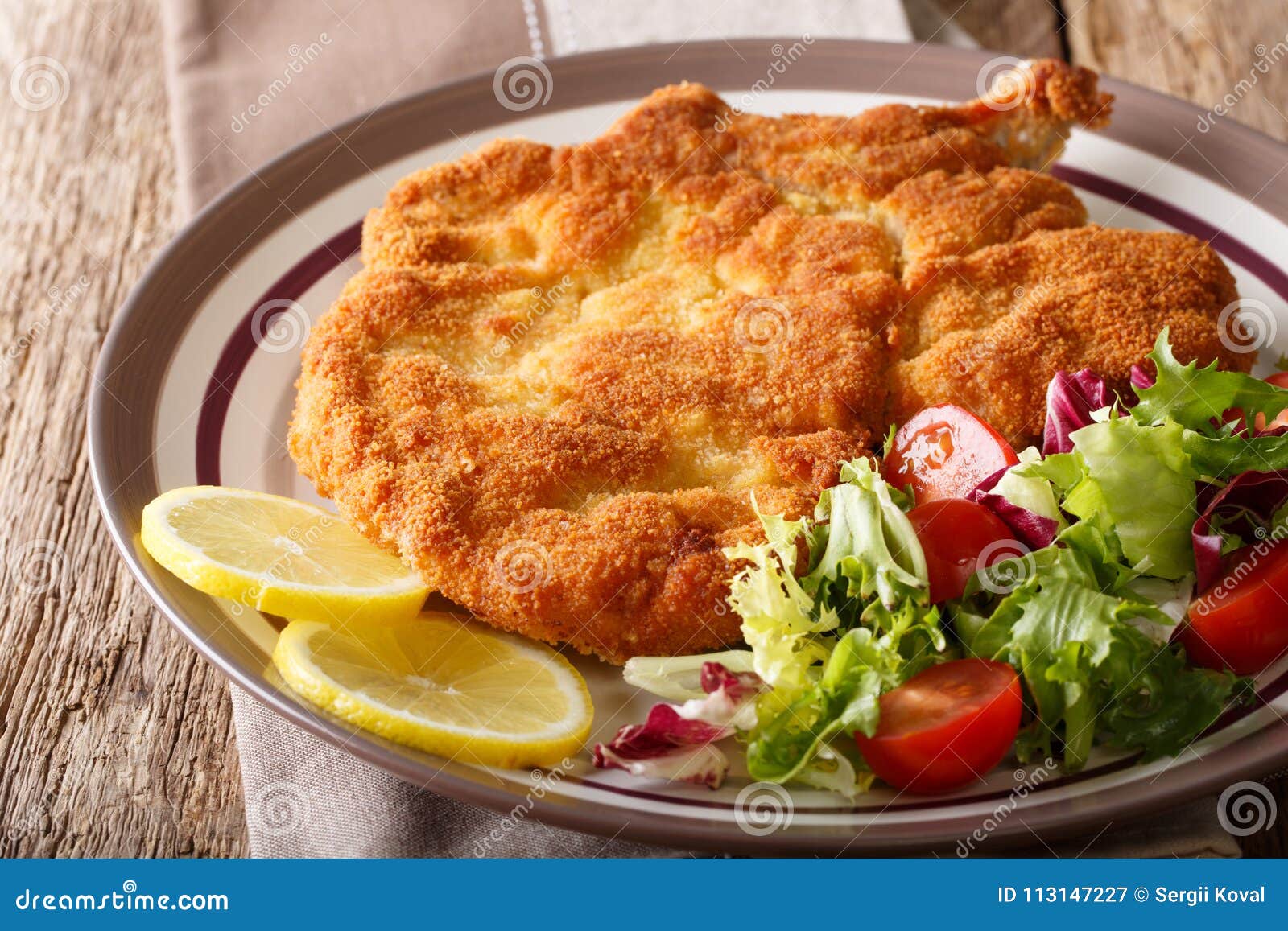 veal milanese cotoletta alla milanese with lemon and fresh veg