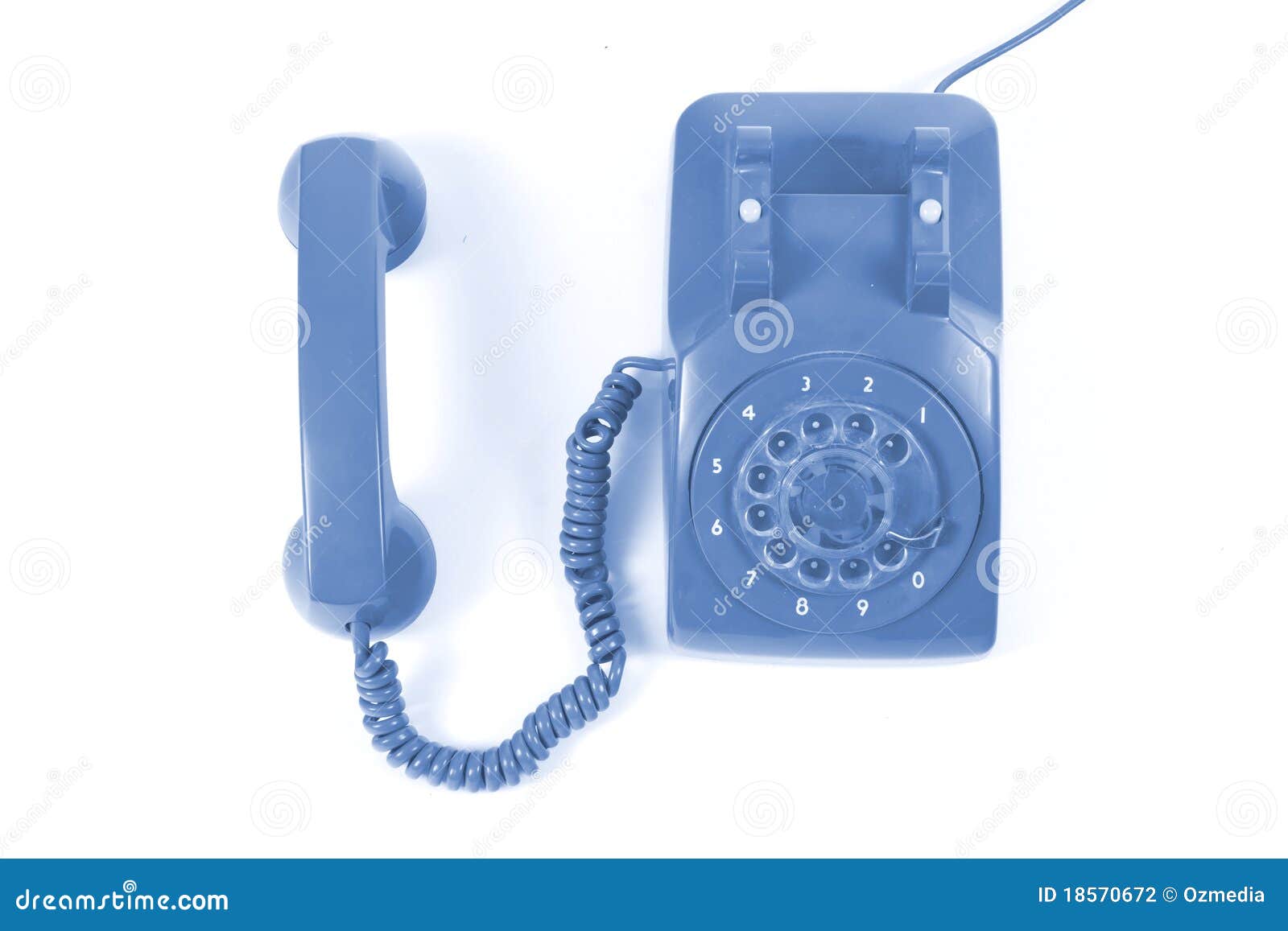 Un vecchio telefono variopinto davanti a priorità bassa bianca