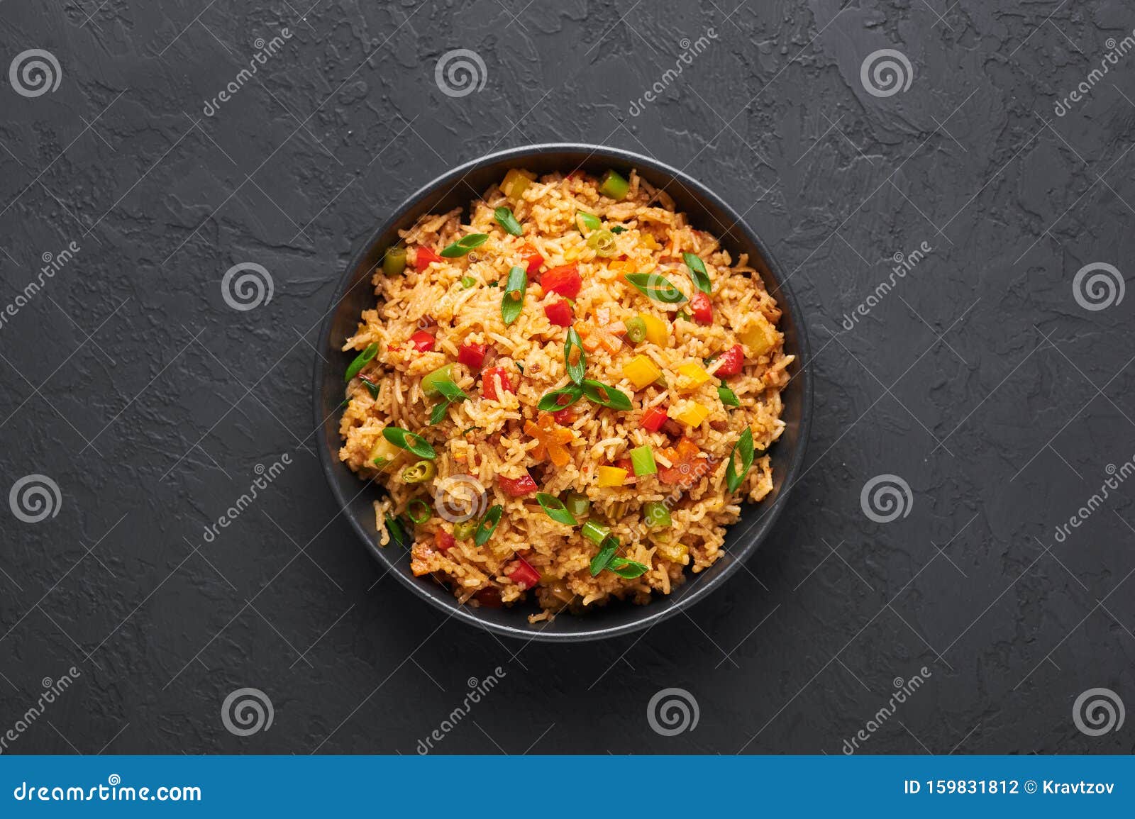 veg schezwan fried rice in black bowl at dark slate background. indo-chinese cuisine dish