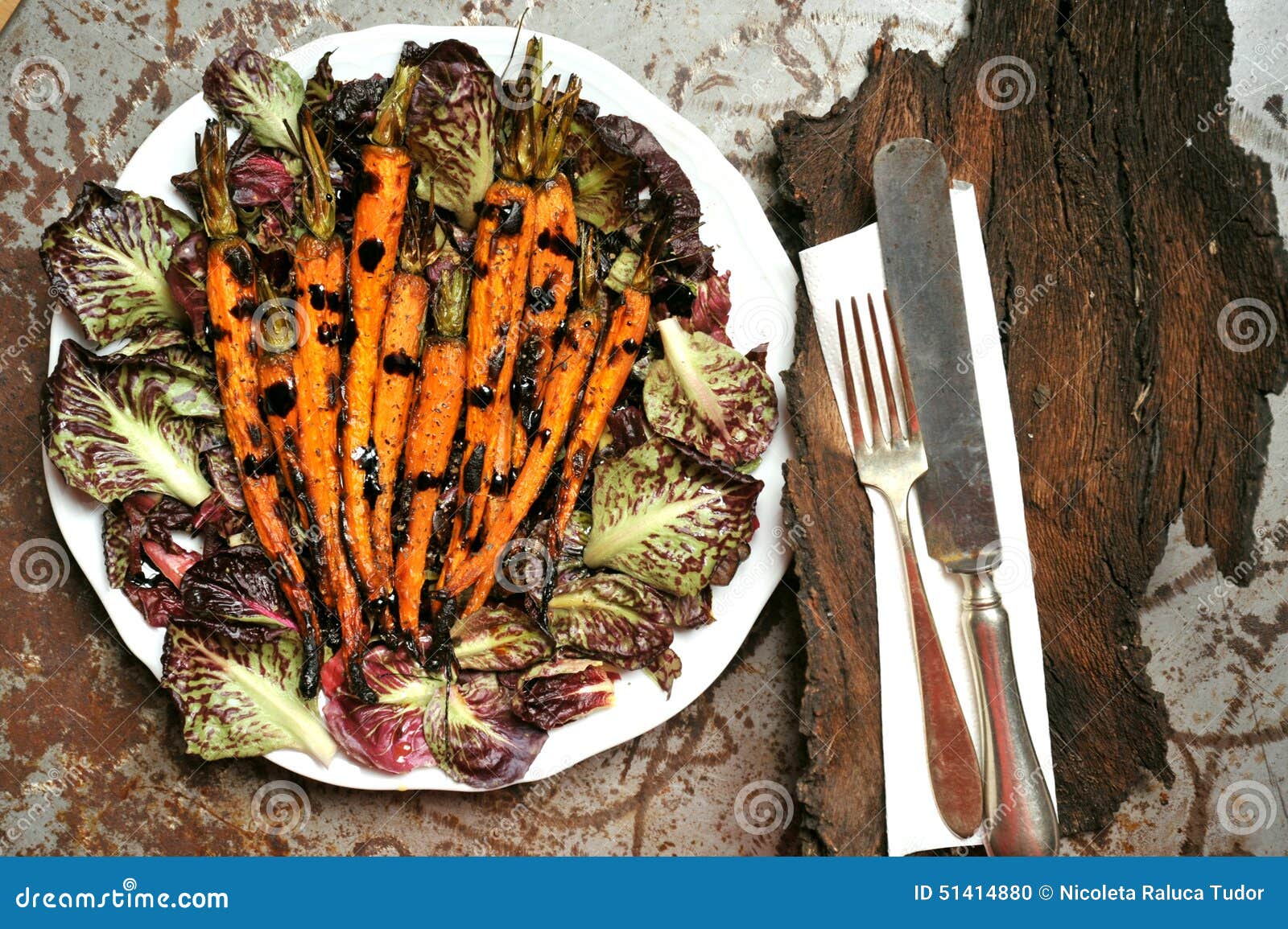 vegan meal with grilled carrots and bitter salad