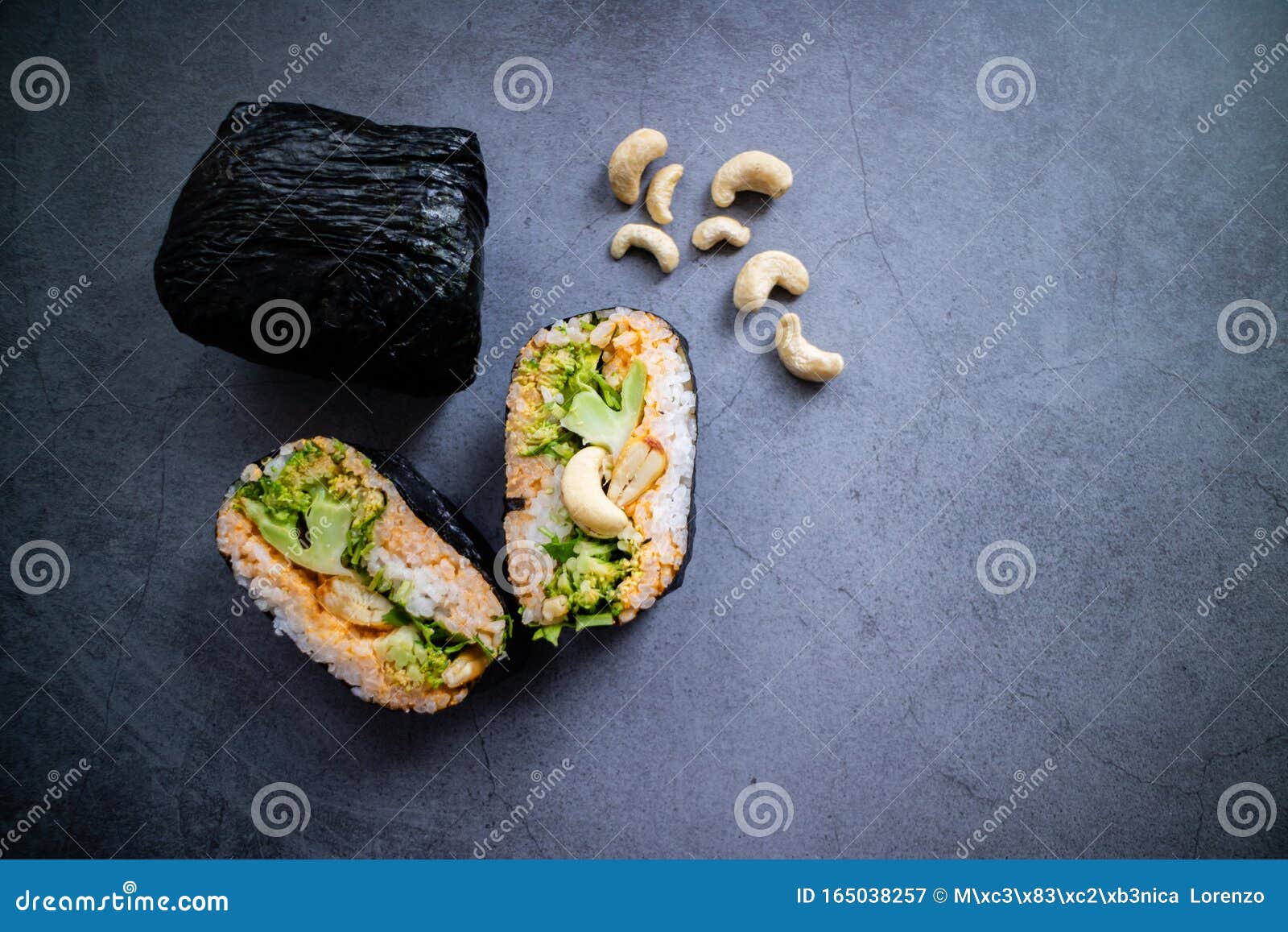 vegan onirigazu with broccoli, cilantro, cashew and curry sauce on concrete background. top view