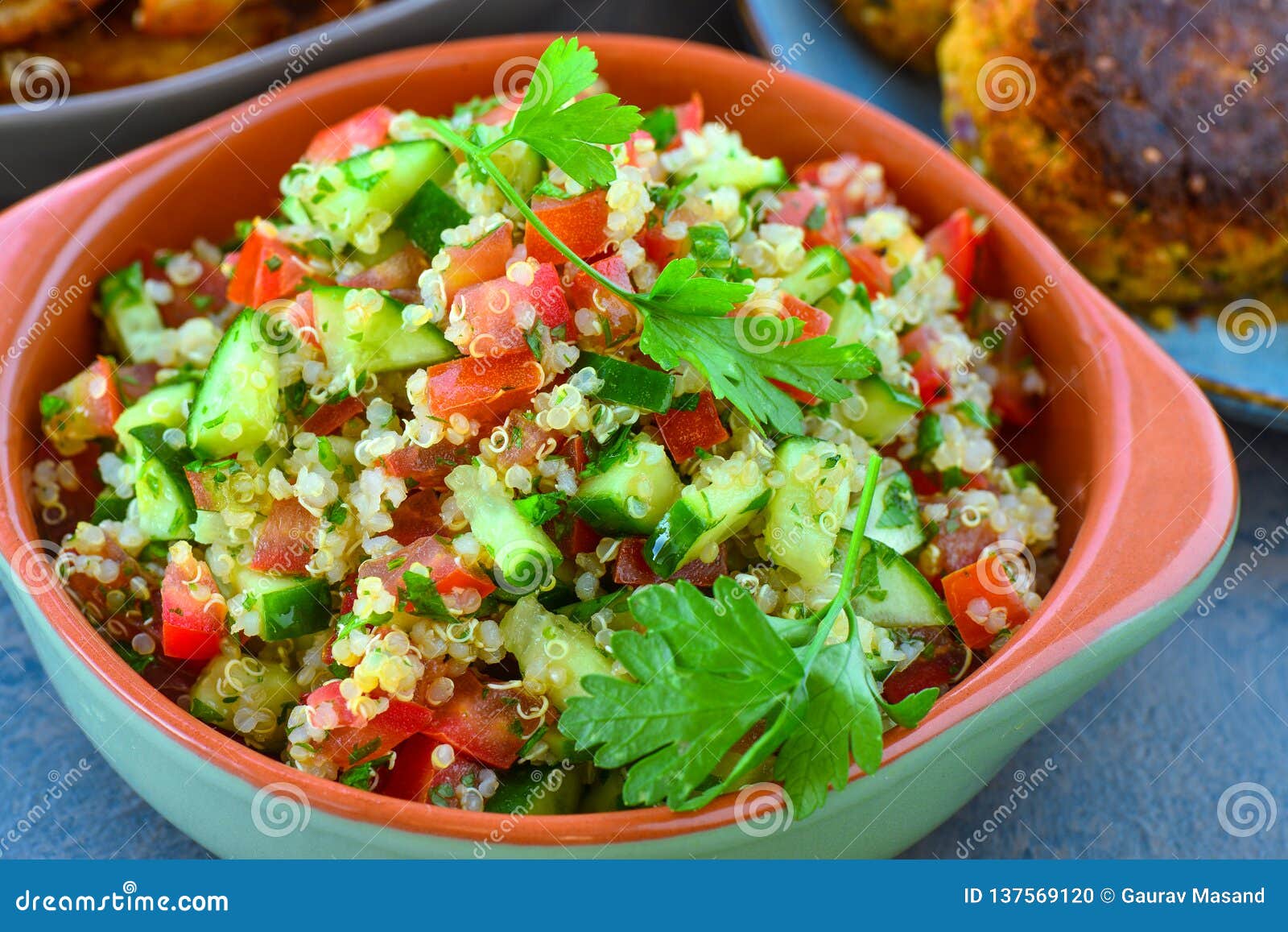 vegan quinoa salad served in earthen bowl