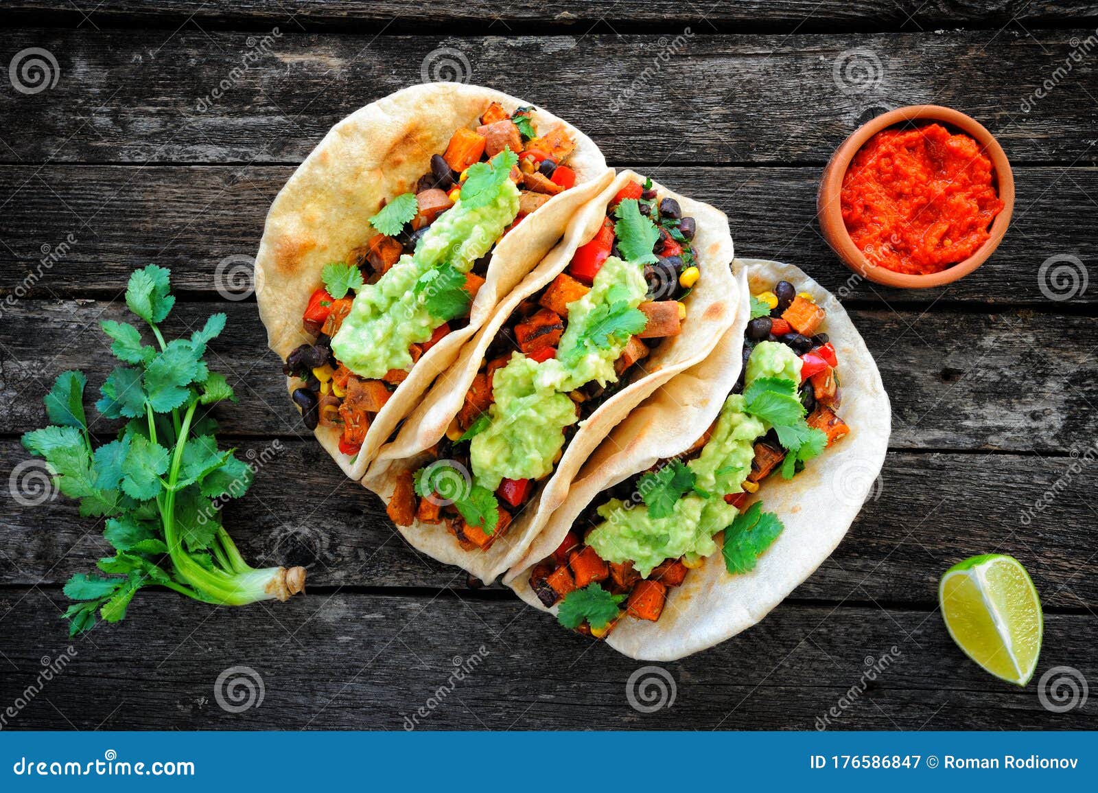 vegan tacos with black beans, sweet potato and guacamole and tortillas flatbread