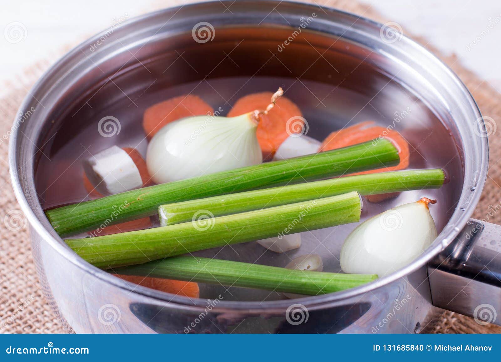Vegetable Broth with Herbs and Carrots in a Saucepan Stock Photo
