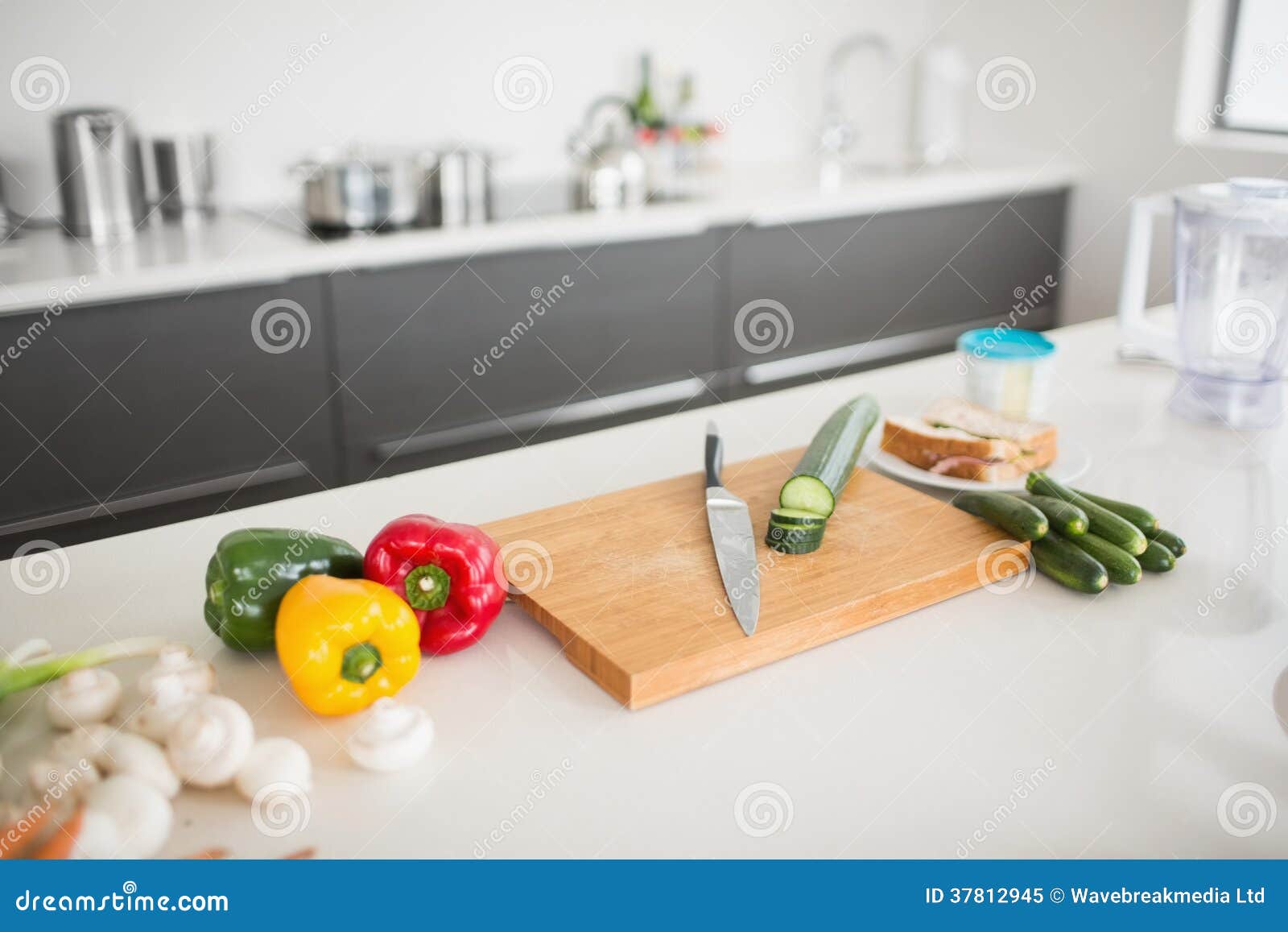 Vegetables with Knife and Chopping Board on Kitchen Counter Stock Image
