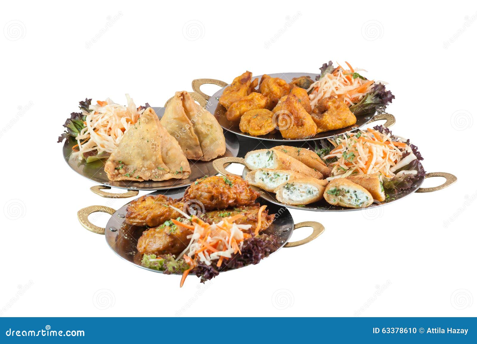 vegetarian indian food or starters on metal plates including samosa on white background