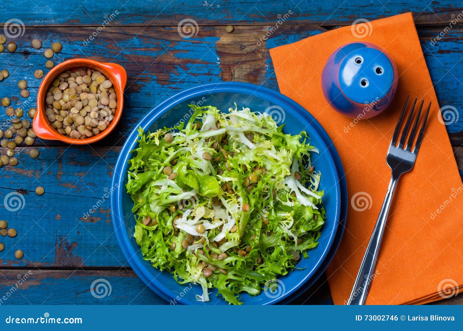 vegetarian salad with lettuce and lentil. colorful blue orange background