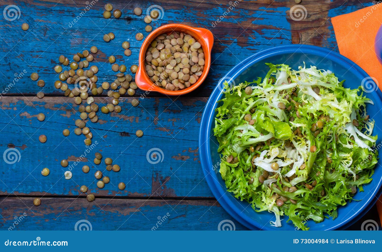 vegetarian salad with lettuce and lentil. colorful blue orange background