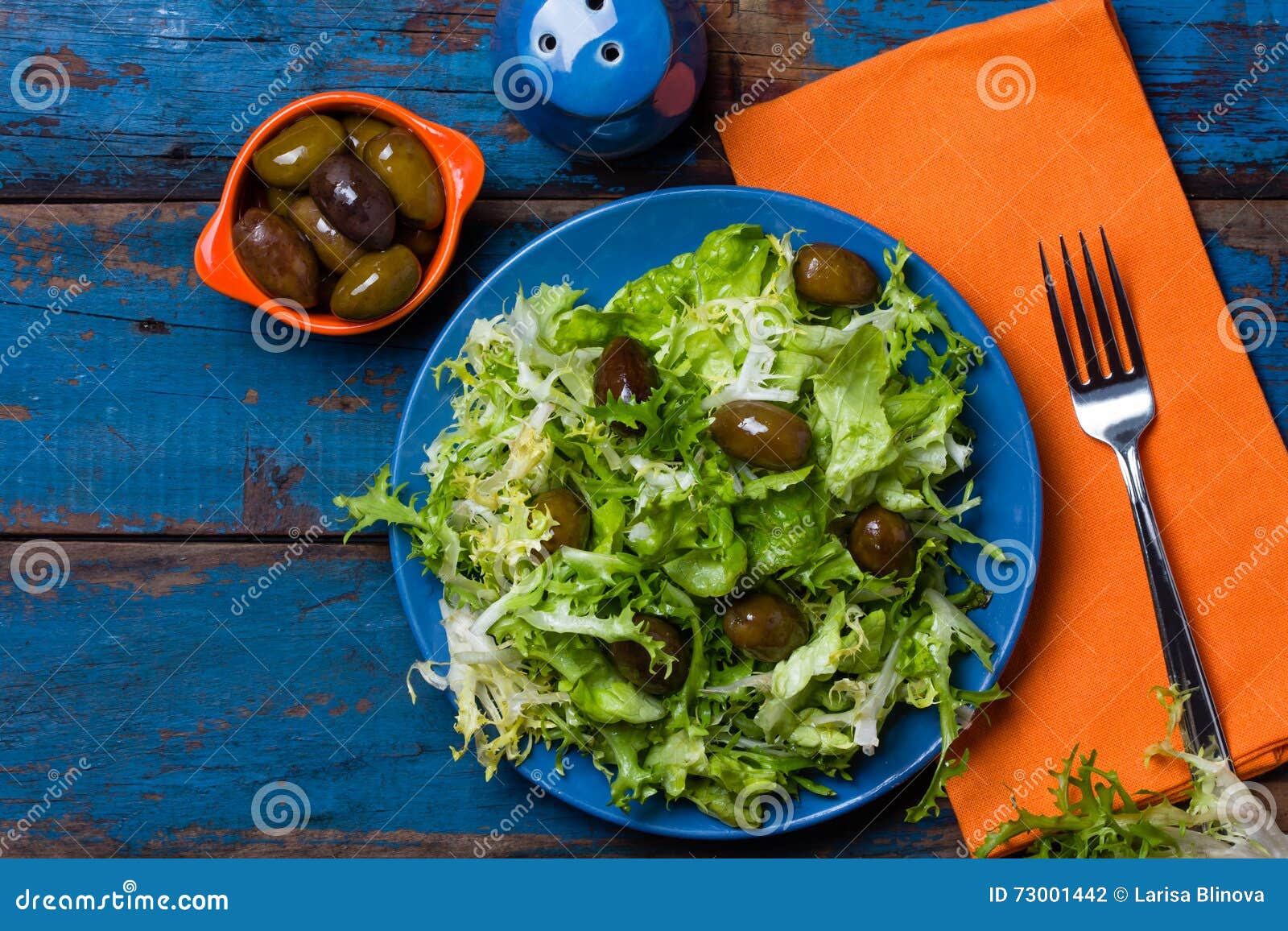 vegetarian salad with lettuce and olives. colorful blue orange background