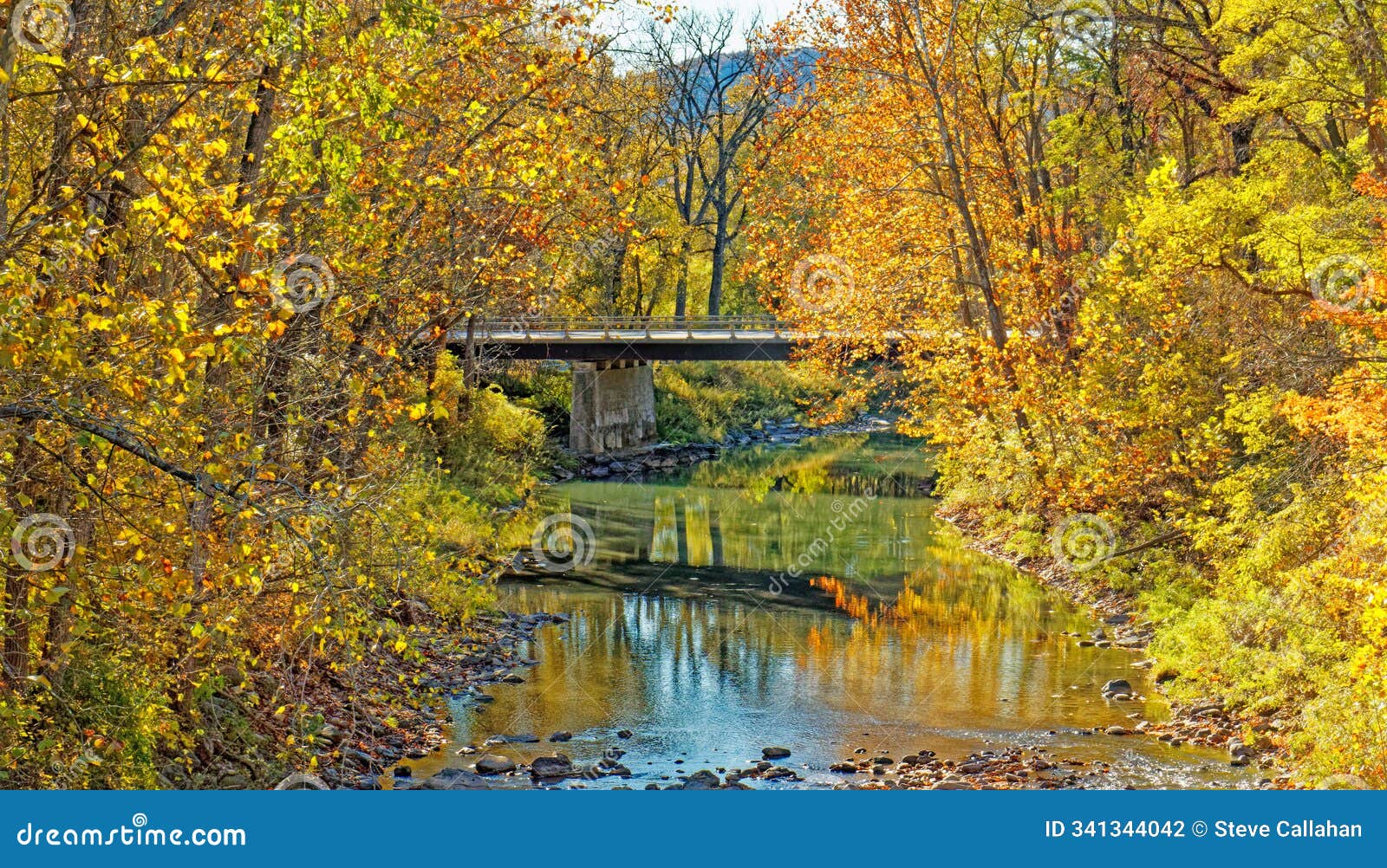 vehicle bridge over fox creek in fall color during low water level lack of rain
