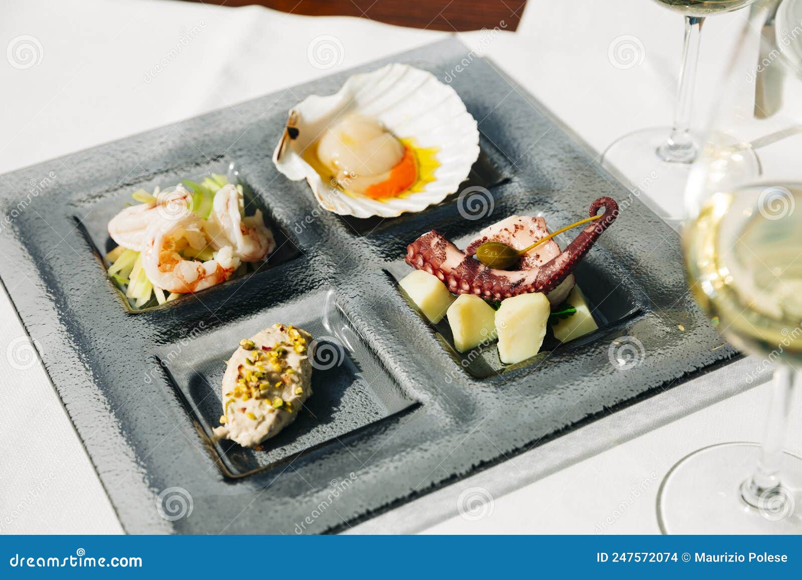 venetian cicchetti with shrimps, scallop, octopus and potatoes, and sea bass