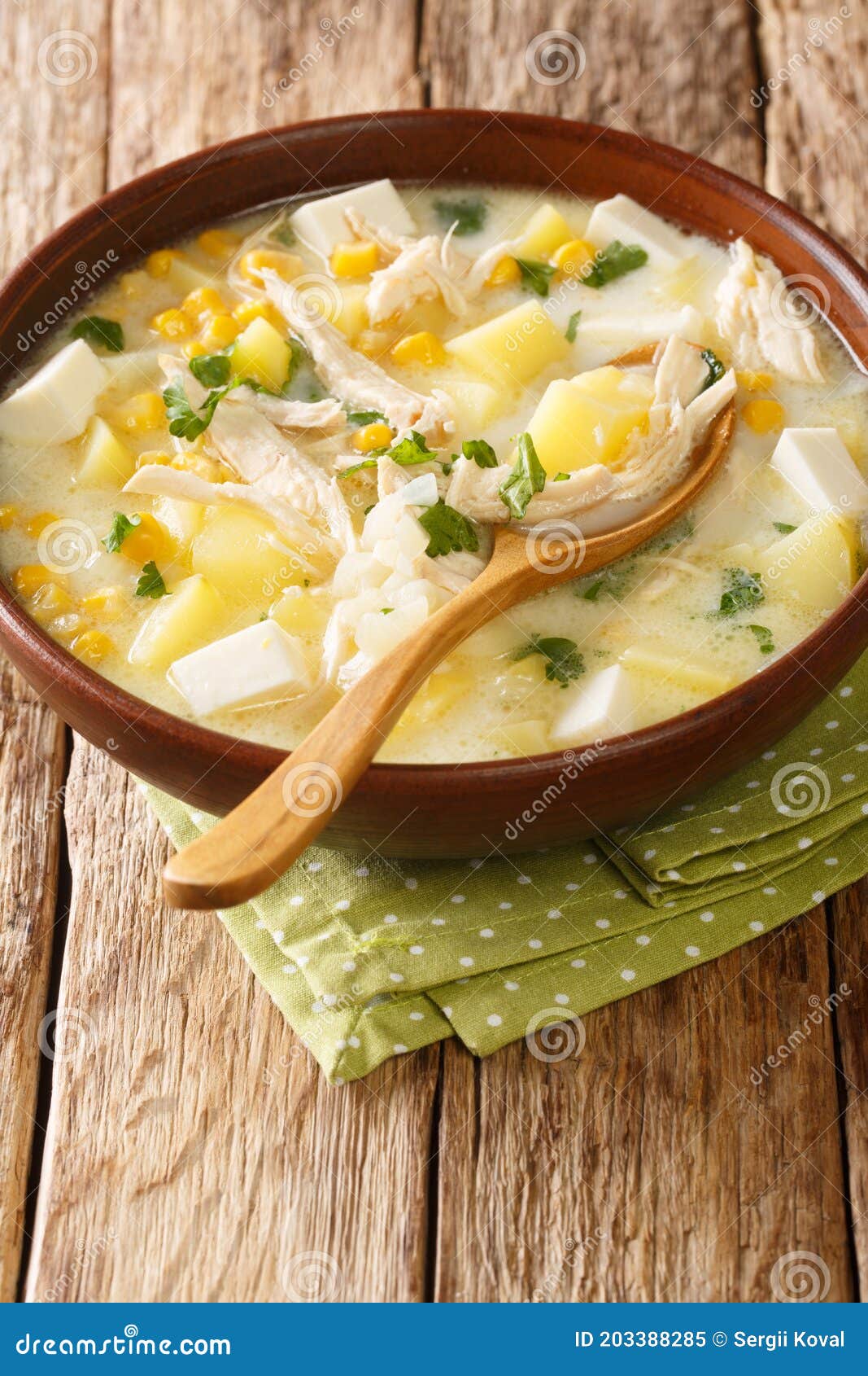 venezuelan chupe andino soup with chicken, cheese, vegetables and cream close-up in a bowl. vertical