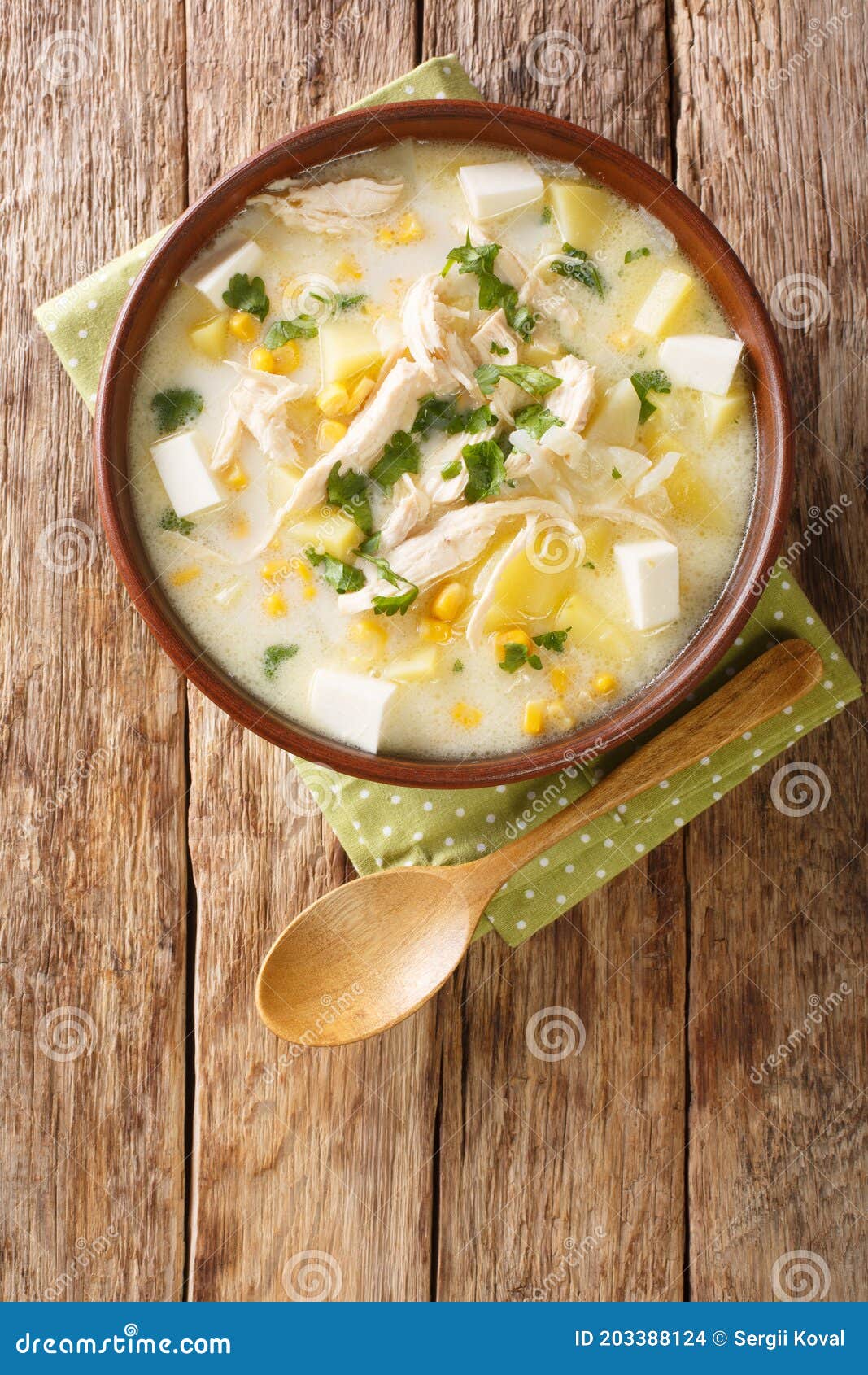 venezuelan chupe andino soup with chicken, cheese, vegetables and cream close-up in a bowl. vertical top view