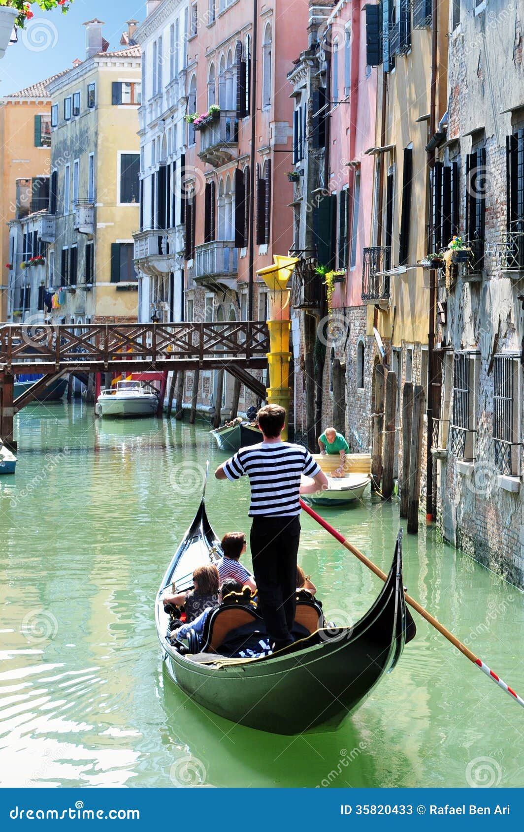 venice cityscape - gondolier rowing gondola editorial