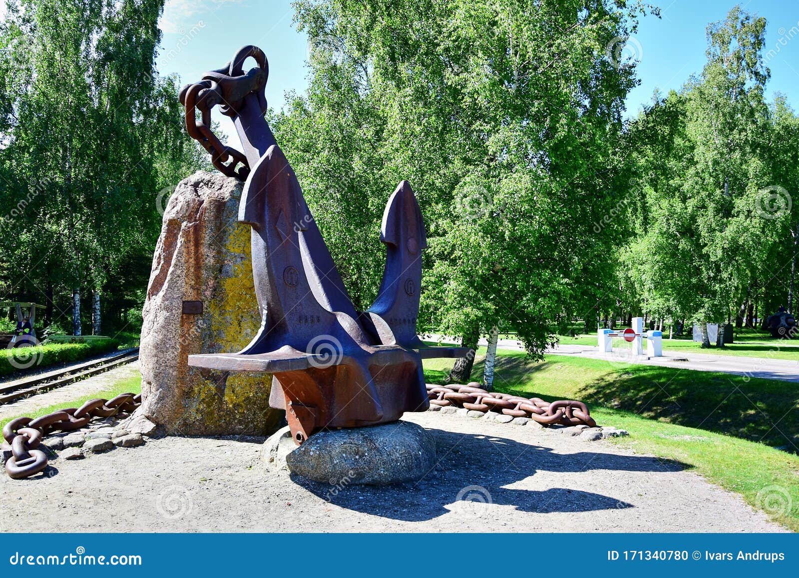 A Monument of a Large Rusty Anchor with a Chain and Boulders Stock ...