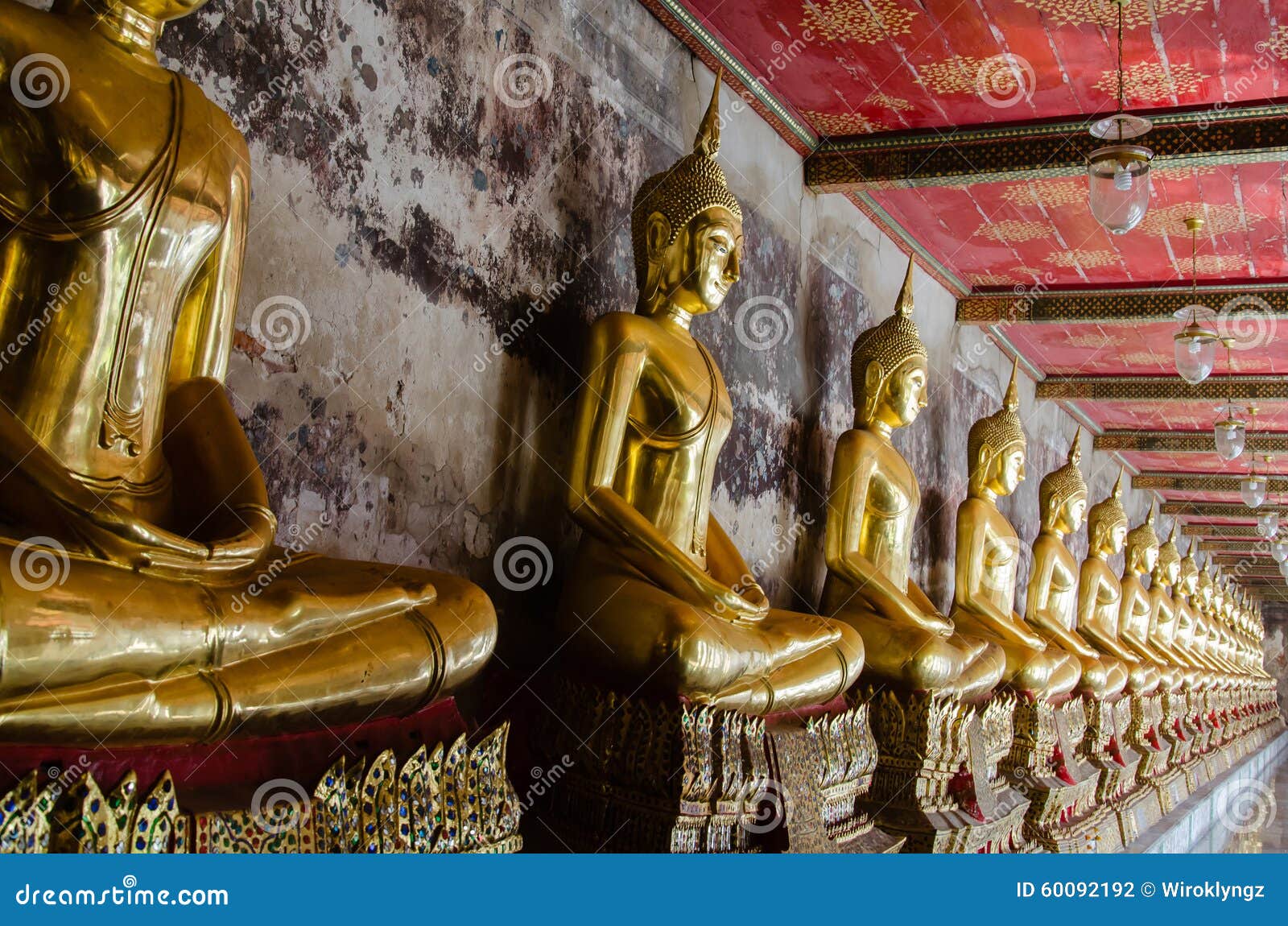 veranda of gild buddha sculptures at wat suthat, bangkok of thailand.