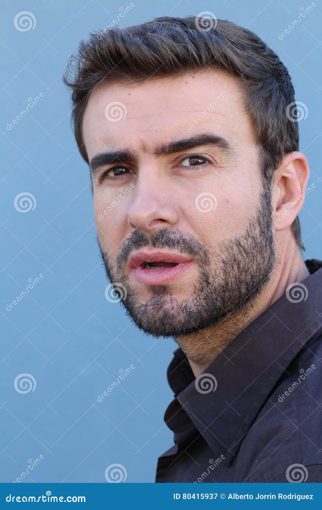 Vertical Close Up Portrait of a Young Man with a Confused, Thinking ...