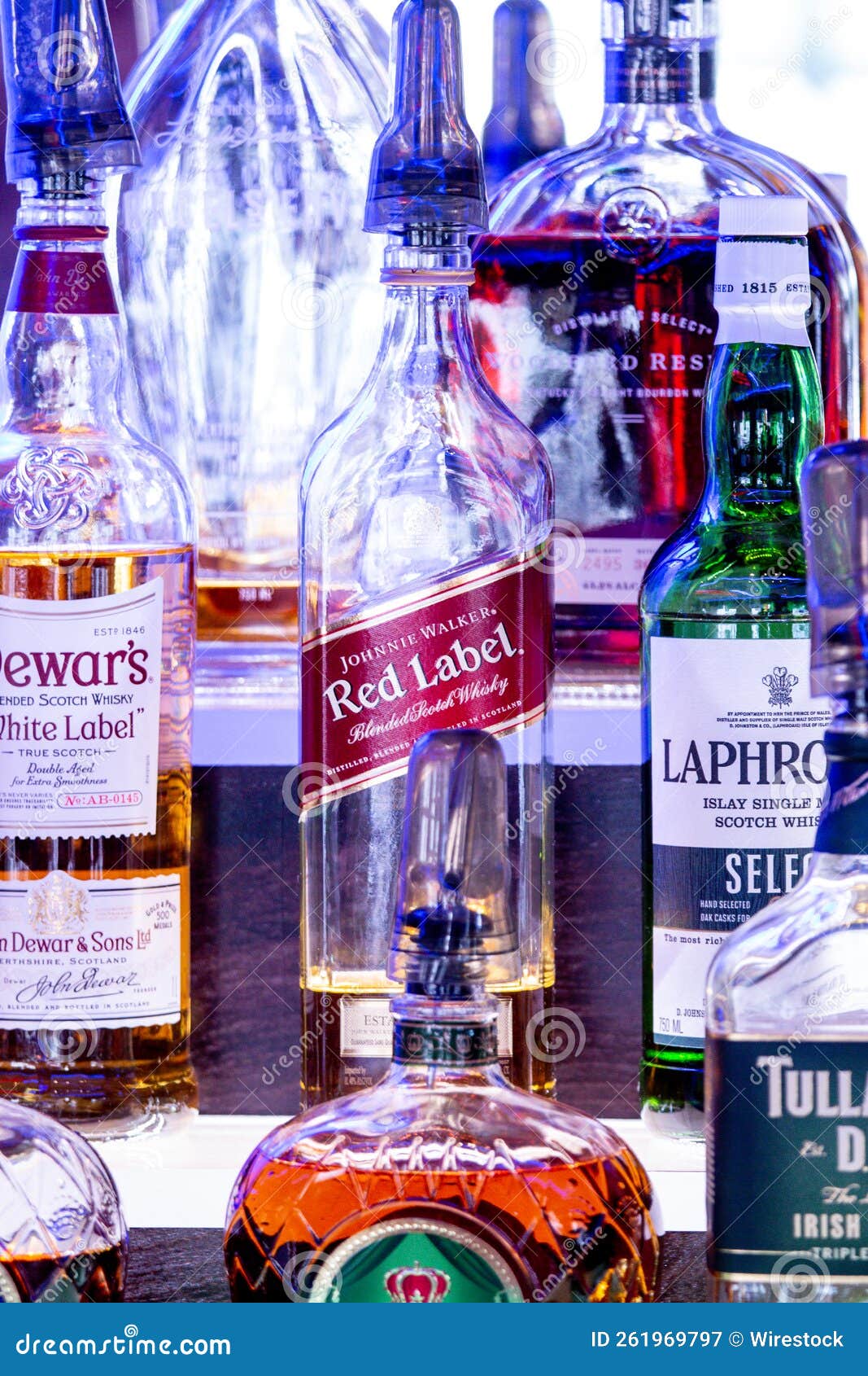 Vertical Closeup of Liqueur Bottles with Good Lighting. Editorial