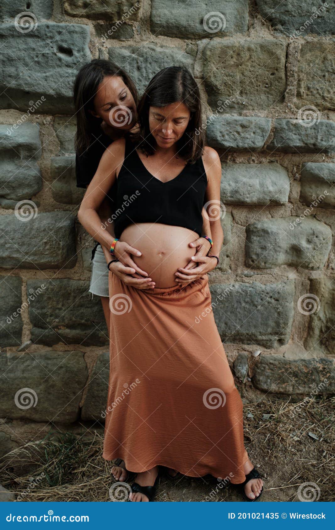 Vertical Closeup Of A Pregnant Lesbian Couple Doing A Photoshoot In A Park Stock Image Image