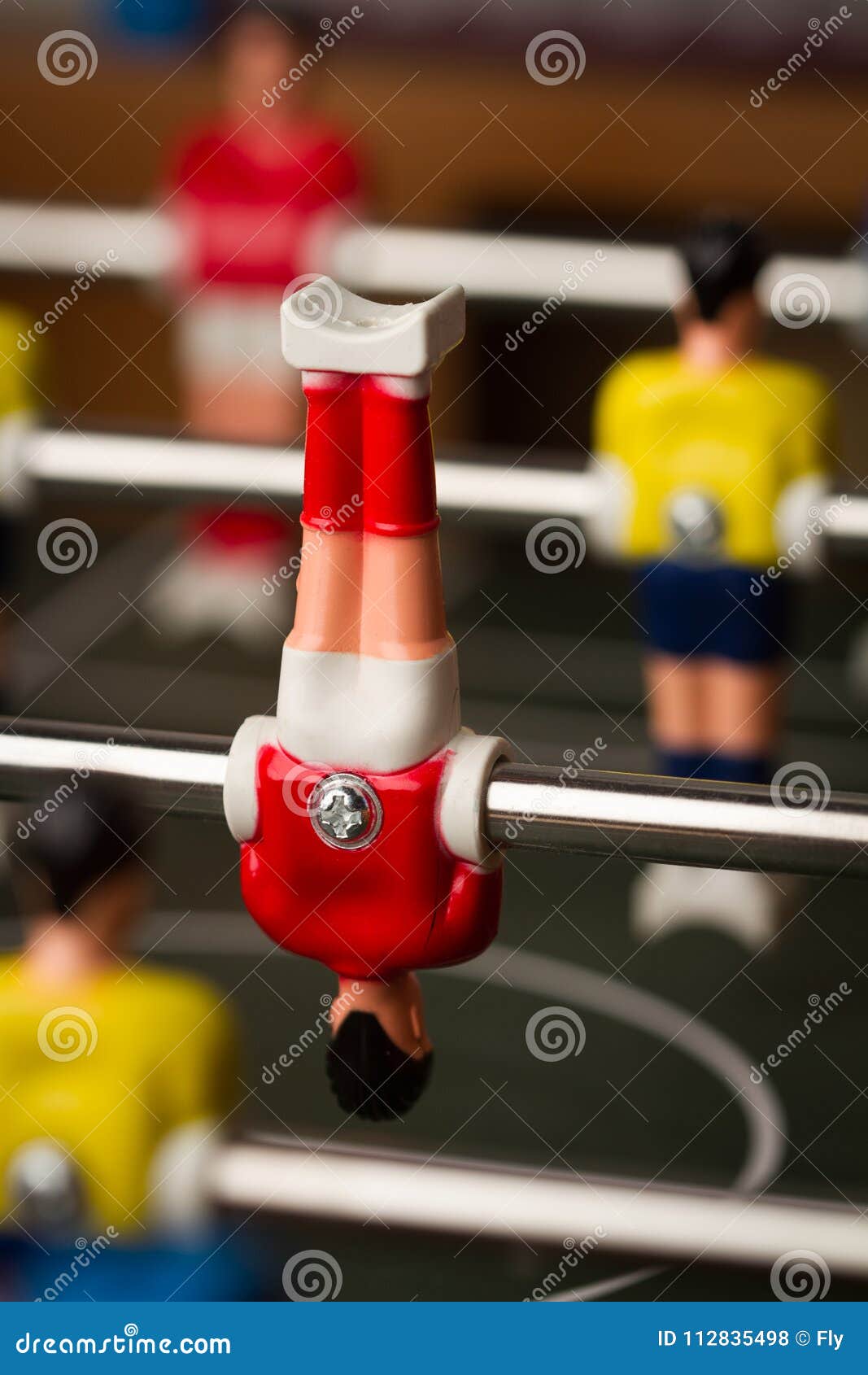 vertical-closeup-selective-focus-red-shirt-player-upside-down-figurine-foosball-table-soccer-game-closeup-upside-112835498.jpg