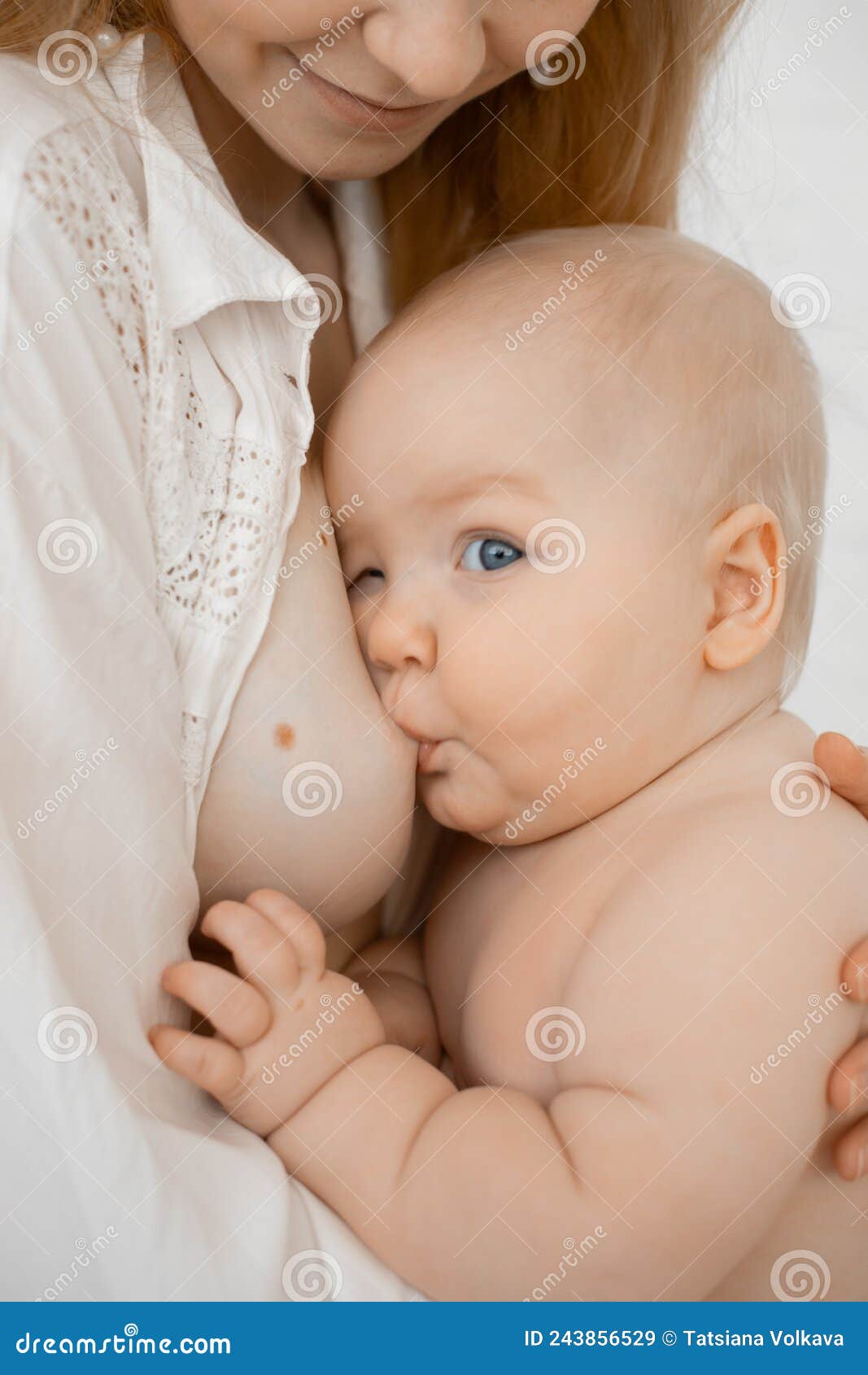 Vertical Cropped of Bare Woman with Small Baby Eating