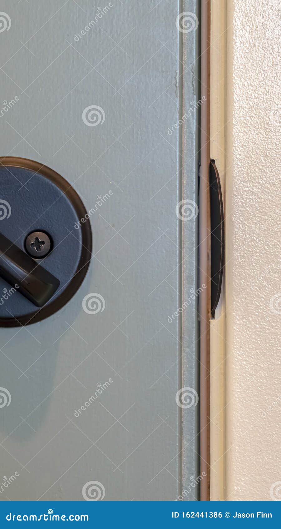Vertical Frame Close Up Of Unlocked Deadbolt Latch On Home Door Stock Photography