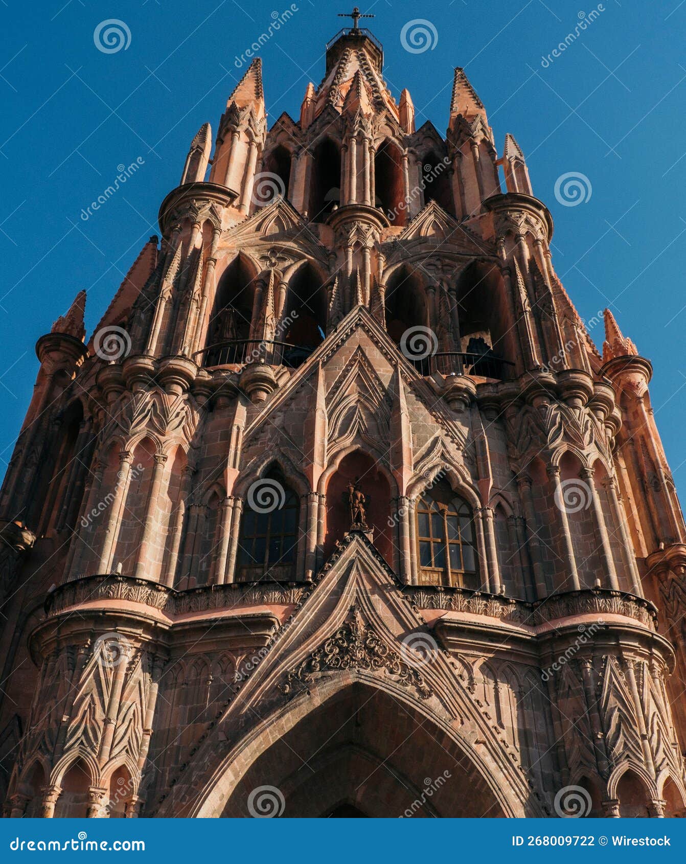 vertical low-angle of the parroquia de san miguel arcangel church in mexico against the blue sky
