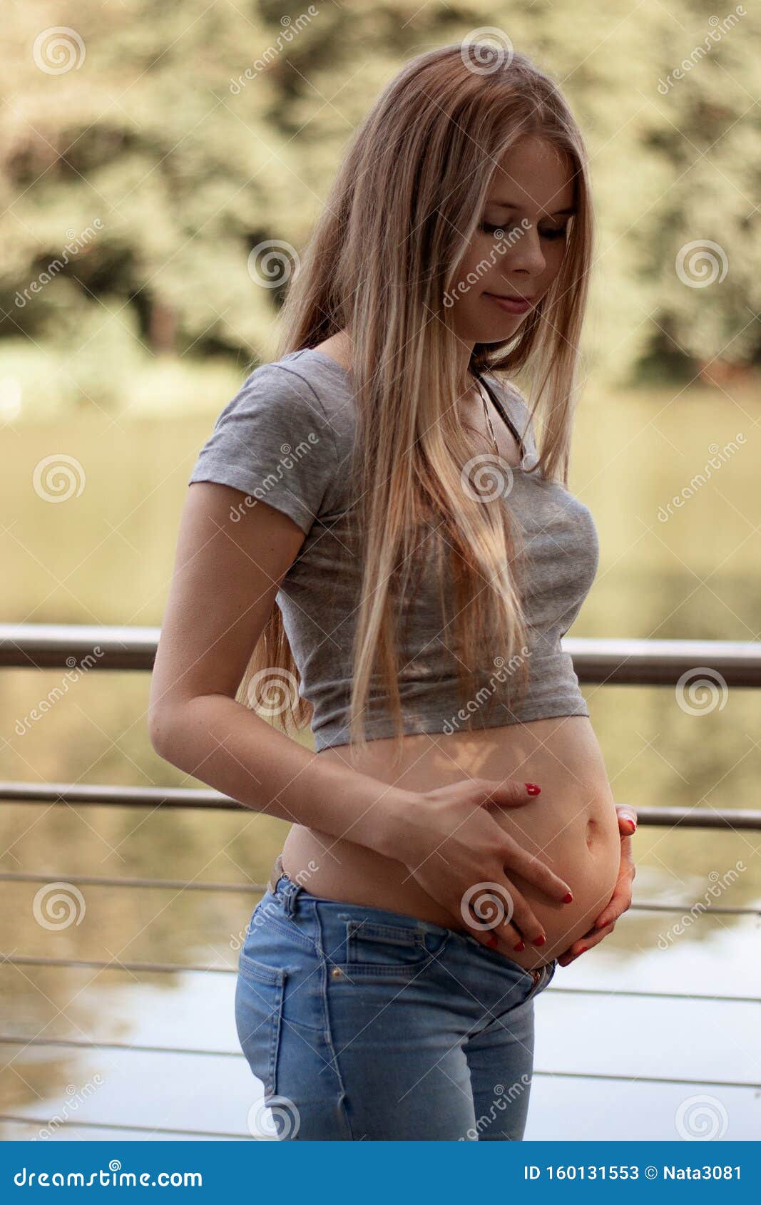 Vertical shot of cute happy european young pregnant woman in