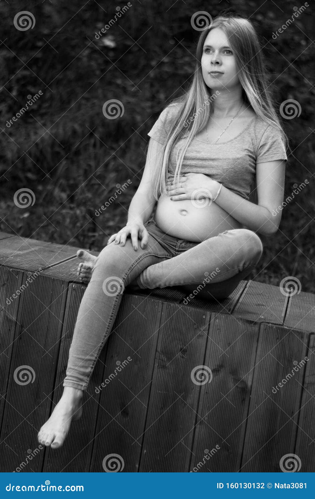 Vertical shot of cute happy european young pregnant woman in