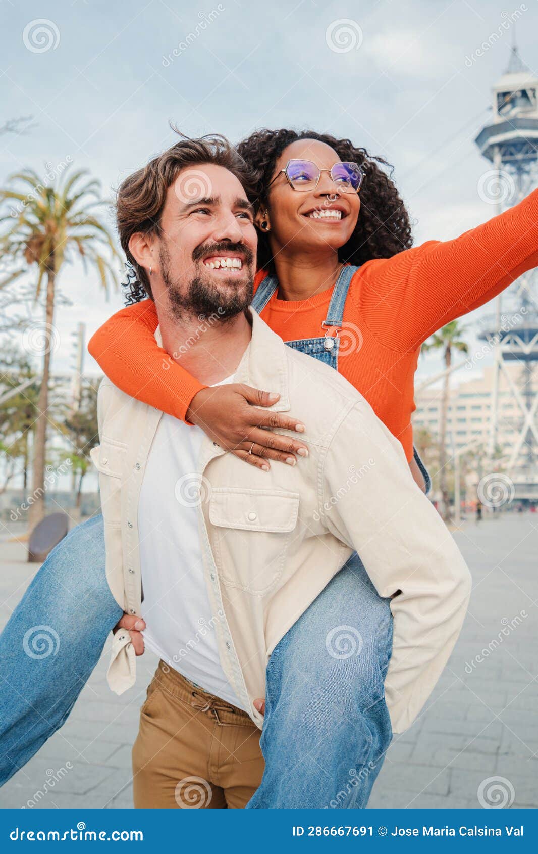 Man giving to girlfriend piggyback ride Stock Photo by ©gstockstudio  147713371