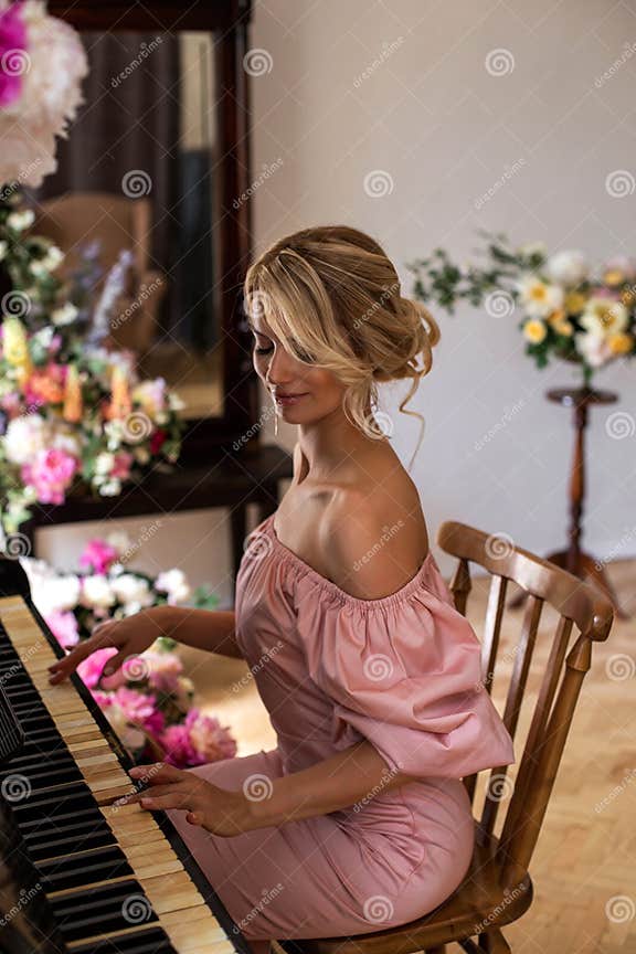 Vertical Portrait Of A Cute Blonde Playing The Piano Stock Image