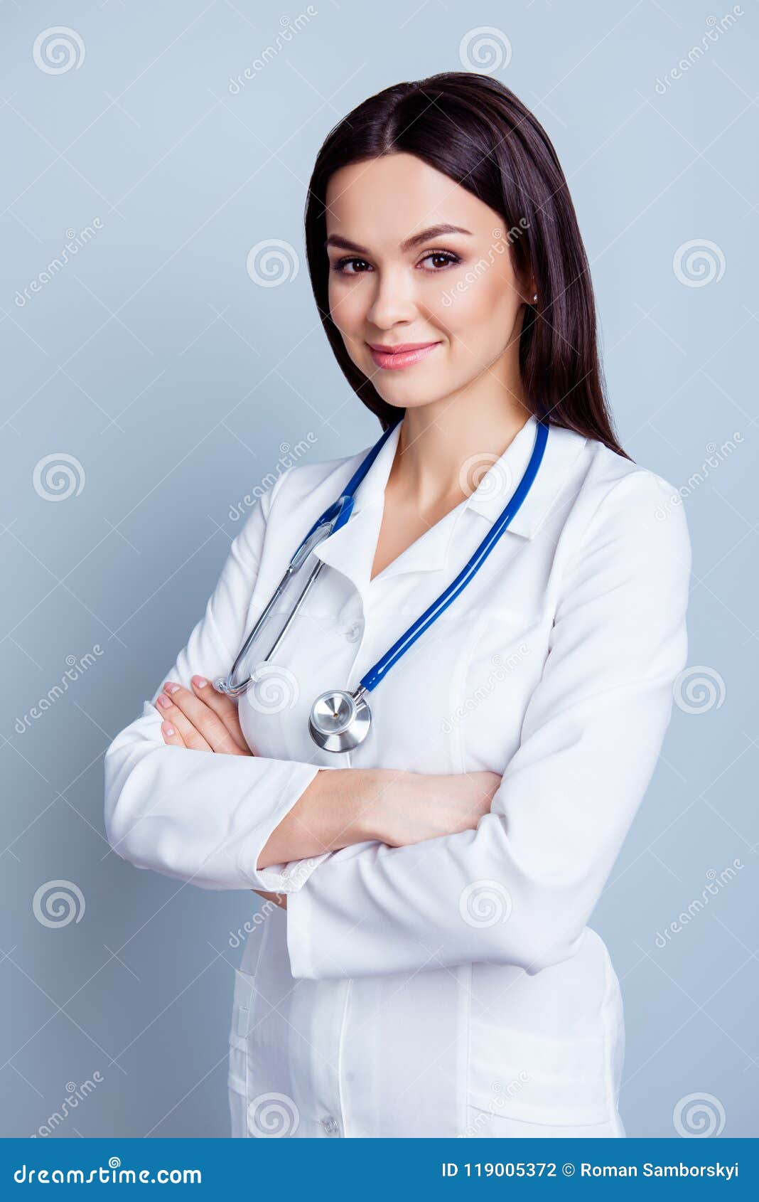 vertical portrait of young confident female medico standing with