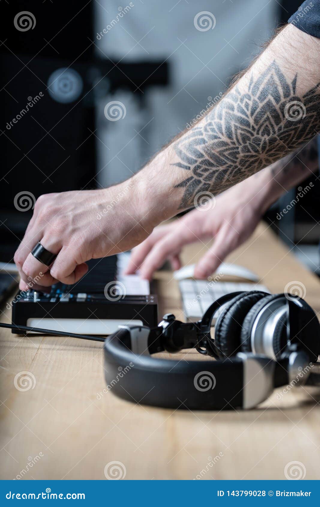 Side View, Close Up And Cropped Photo Tattoo Hands Of Disc Jockey Master.  Professional Man Using Special Controller For Creative Music In Sound  Studio With Trendy Black Modern Interior Stock Photo, Picture